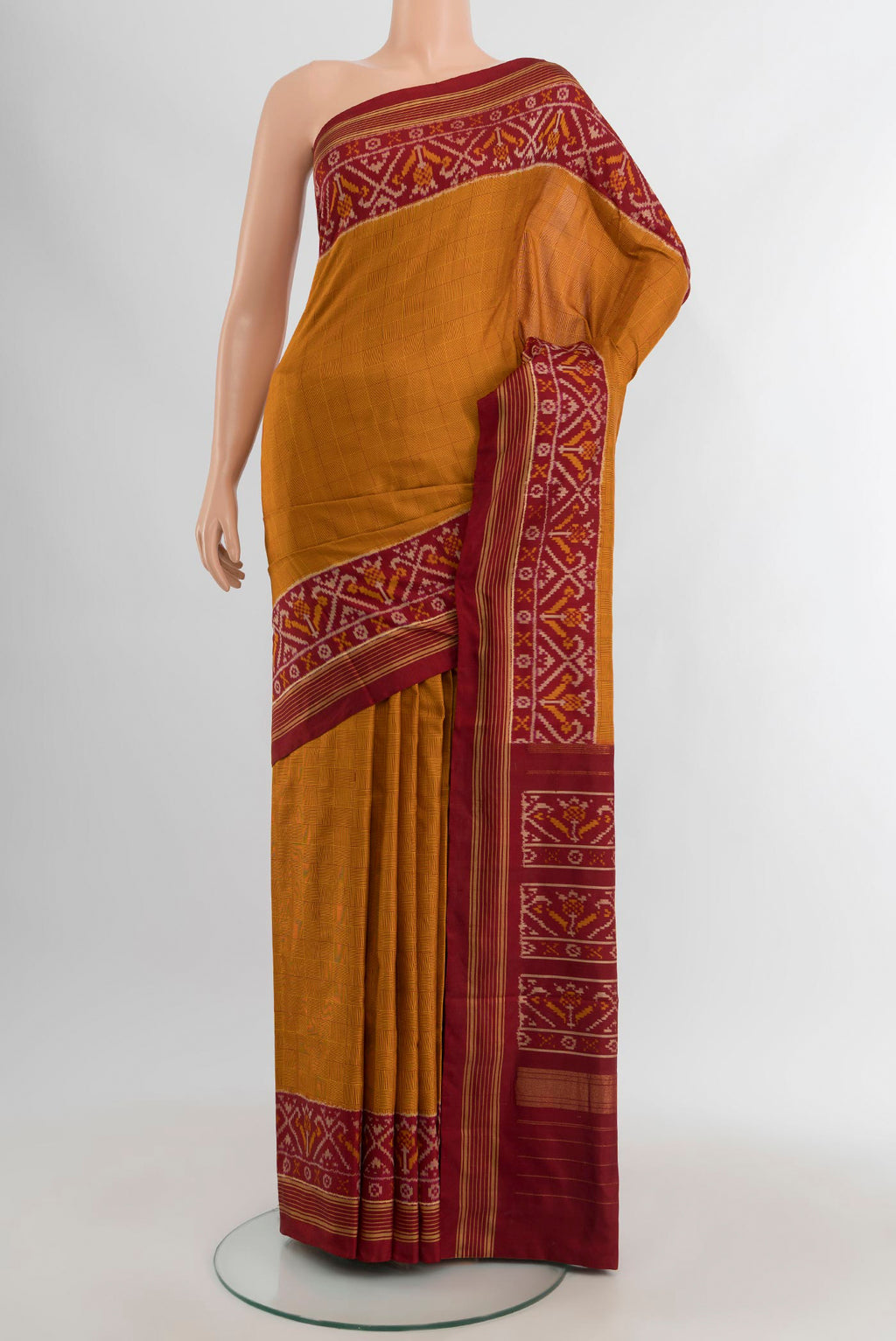 Mustard Pochampally Silk Saree with Checked design on the body and Ikat Border.  displayed on a mannequin