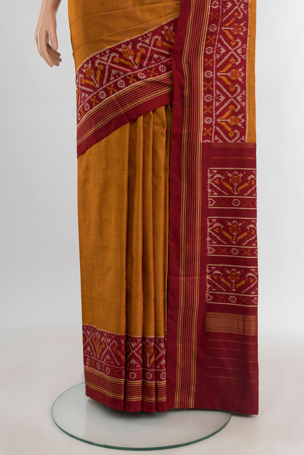 Pleats and pallu of Mustard Pochampally Silk Saree with Checked design on the body and Ikat Border. 