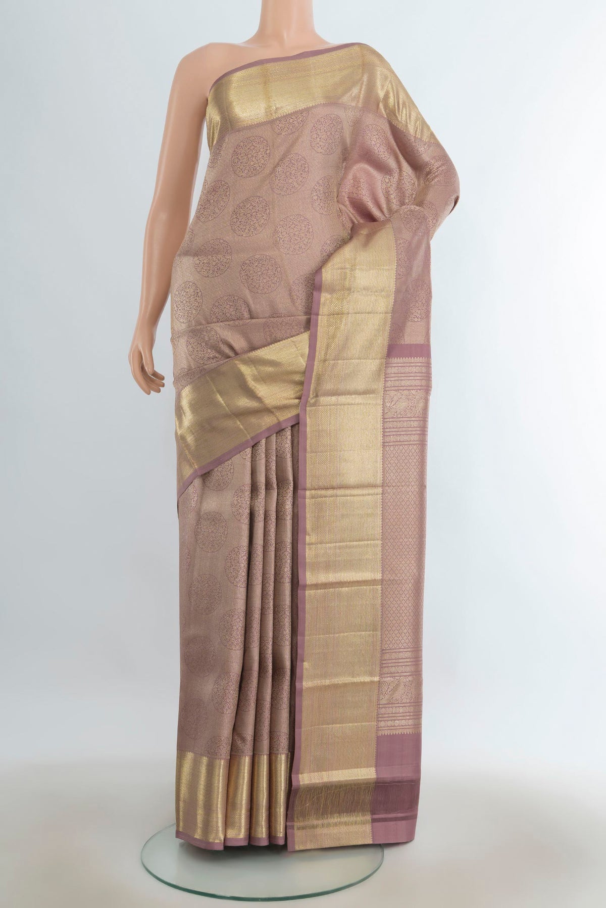 Pure Silk Bronze Kanchipuram Saree with Zari Butta on the body and Silk Border.  displayed on a mannequin