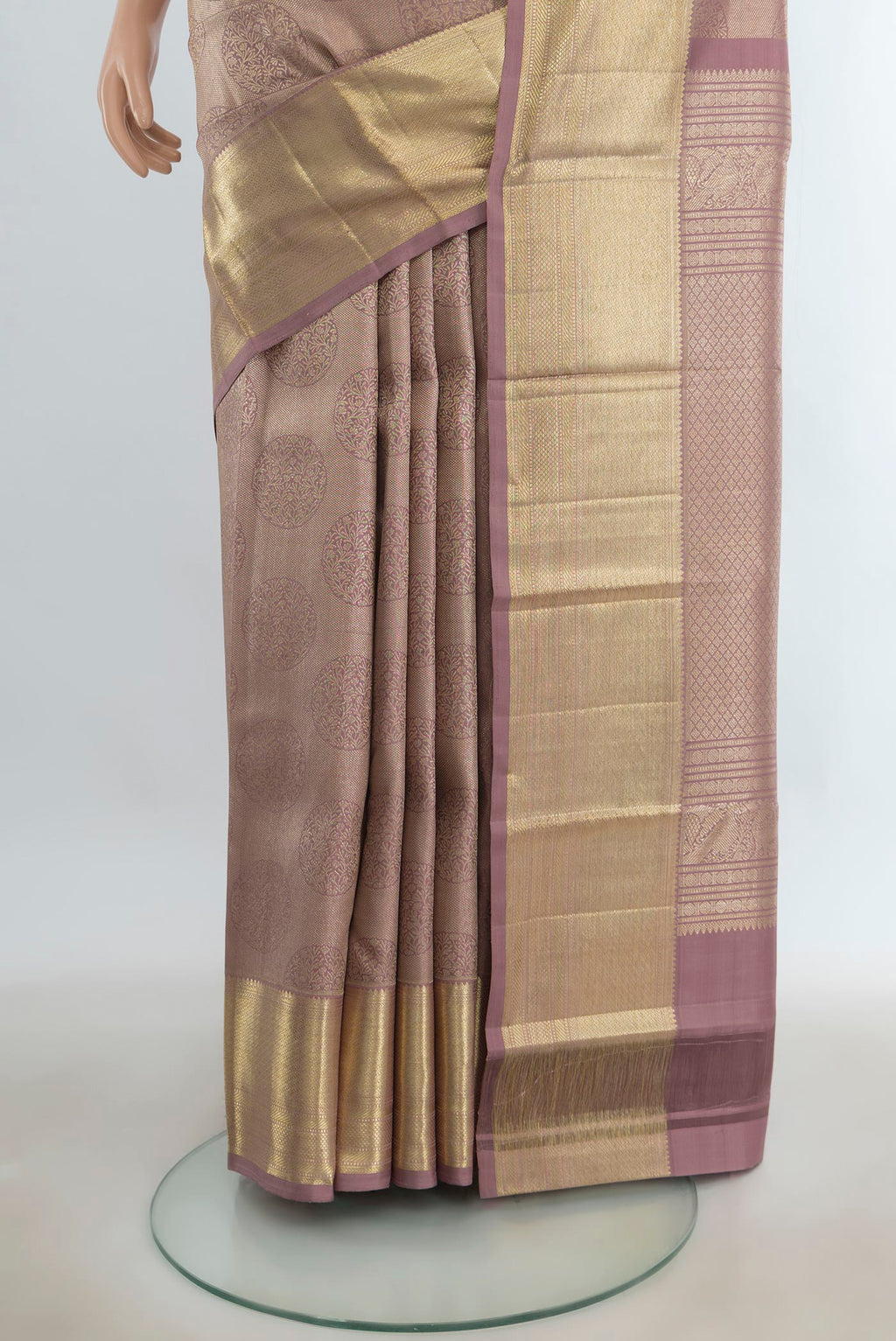 Pleats and pallu of Pure Silk Bronze Kanchipuram Saree with Zari Butta on the body and Silk Border. 