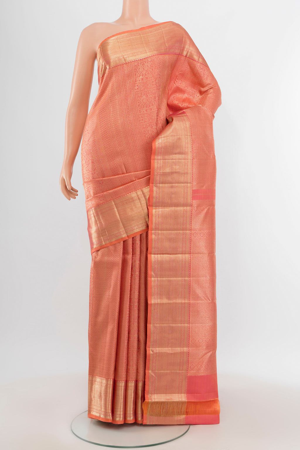 Peach Kanchipuram Silk Saree with Zari Brocade on the body and Zari Border.  displayed on a mannequin