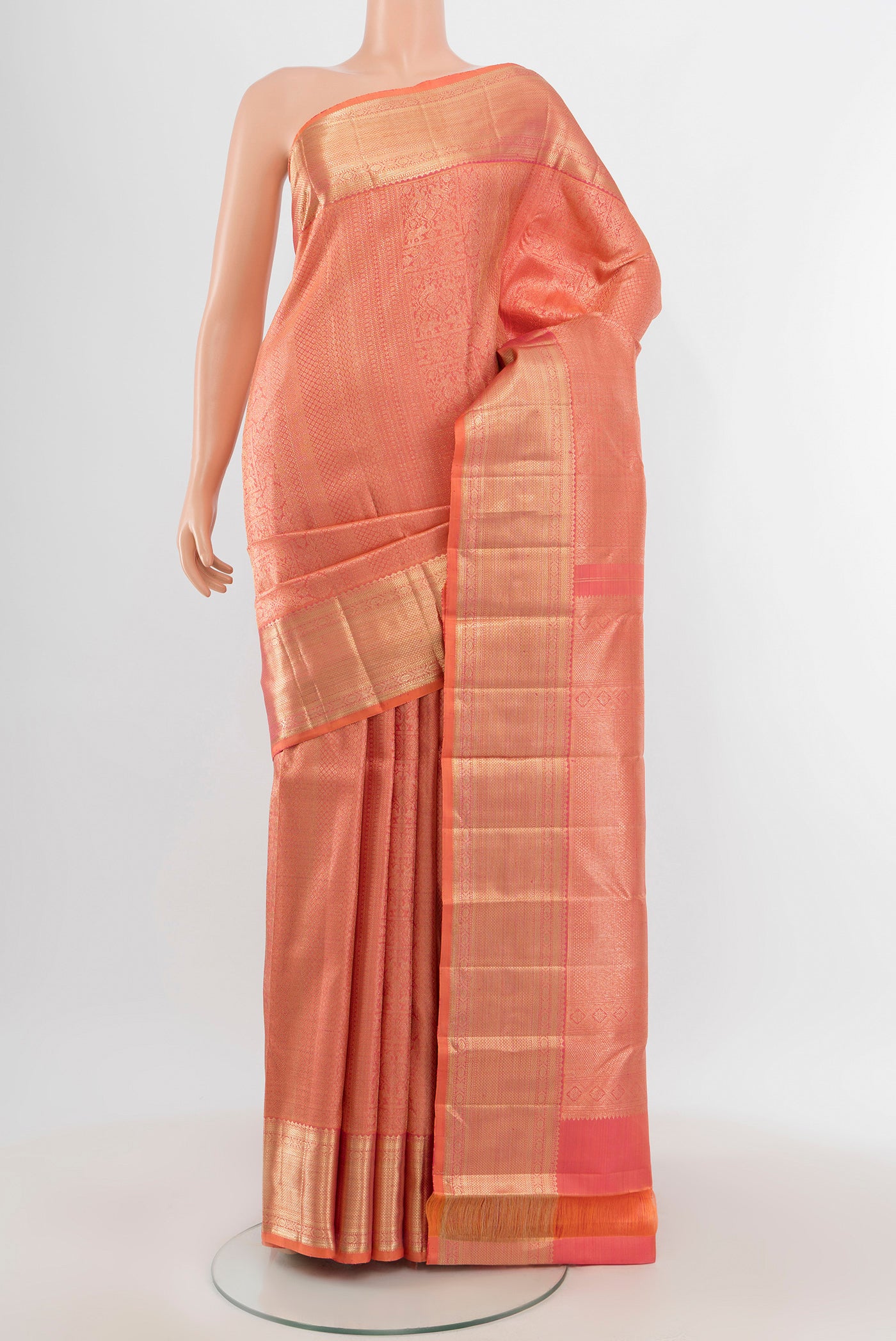 Peach Kanchipuram Silk Saree with Zari Brocade on the body and Zari Border.  displayed on a mannequin
