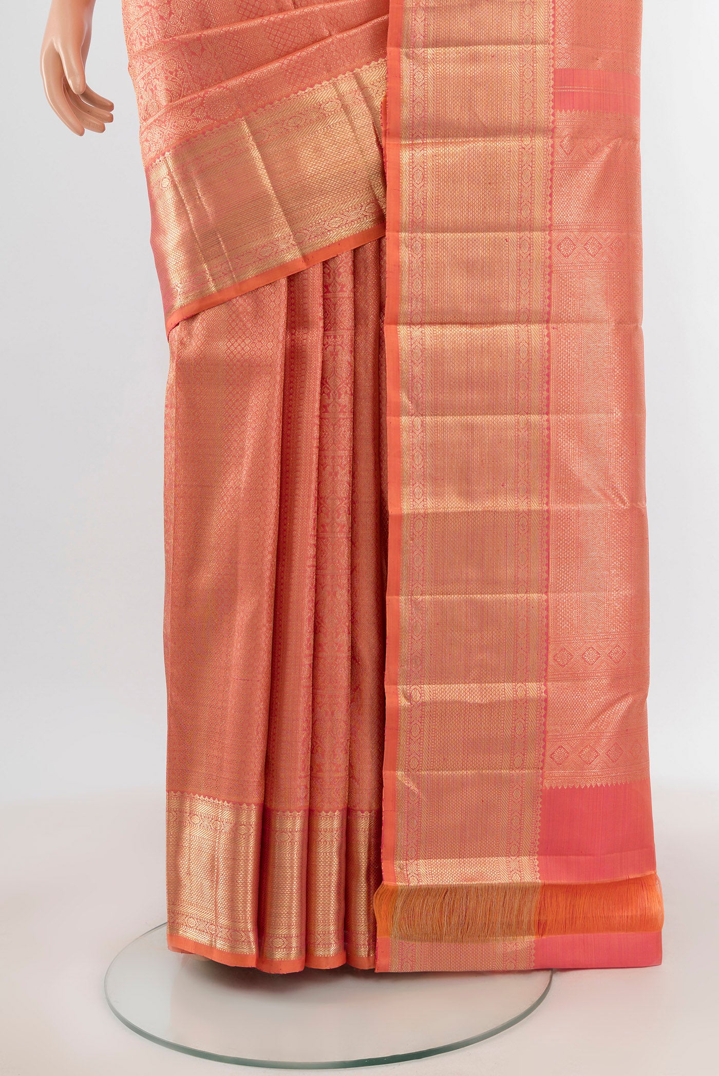 Pleats and pallu of Peach Kanchipuram Silk Saree with Zari Brocade on the body and Zari Border. 
