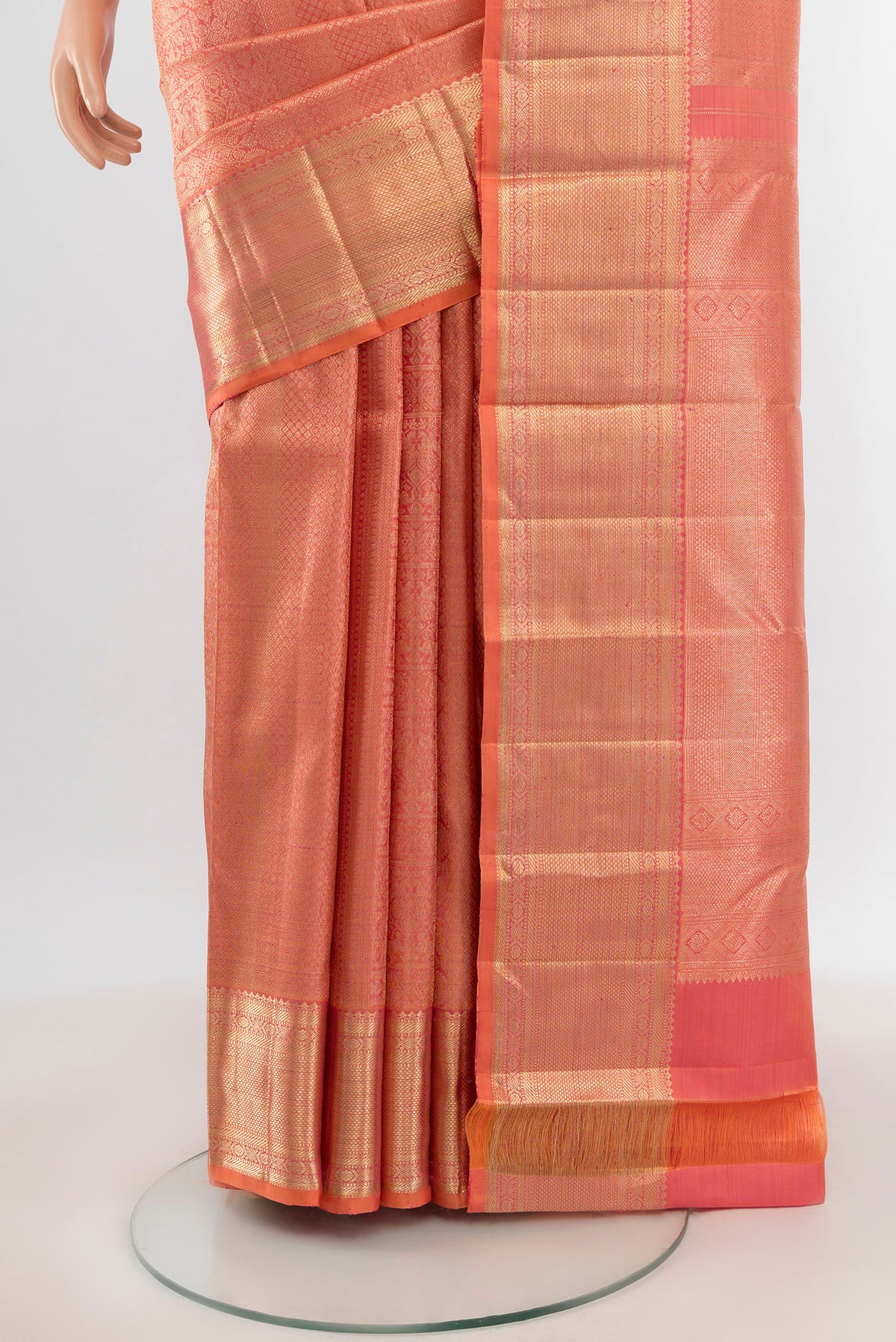 Pleats and pallu of Peach Kanchipuram Silk Saree with Zari Brocade on the body and Zari Border. 