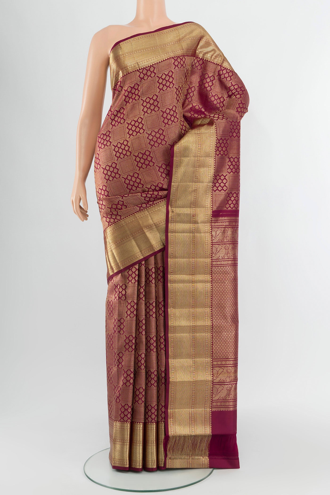 Maroon Kanchipuram Silk Saree with Zari Brocade on the body and Zari Border.  displayed on a mannequin