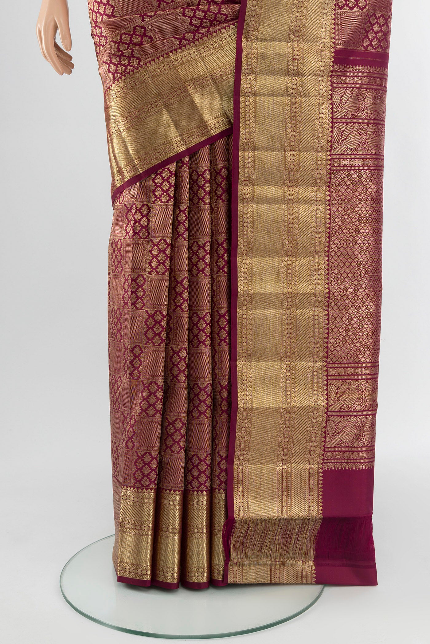 Pleats and pallu of Maroon Kanchipuram Silk Saree with Zari Brocade on the body and Zari Border. 