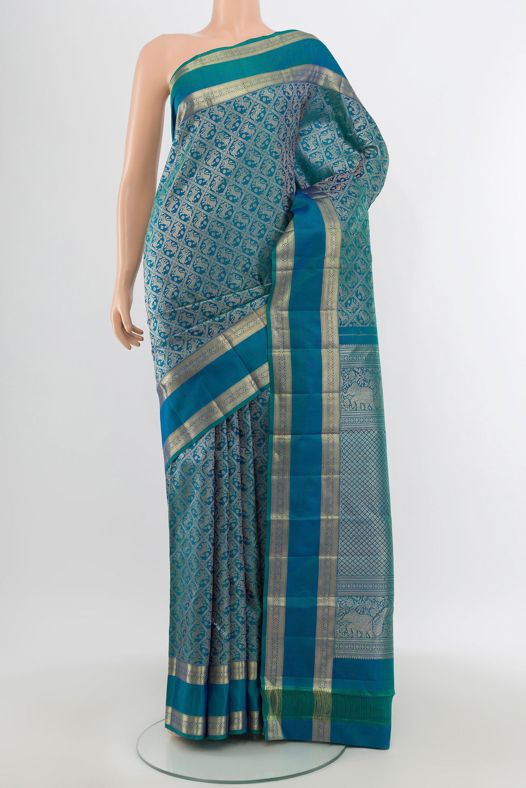 Peacock Blue Kanchipuram Silk Saree with Zari Butta on the body and Zari Border.  displayed on a mannequin