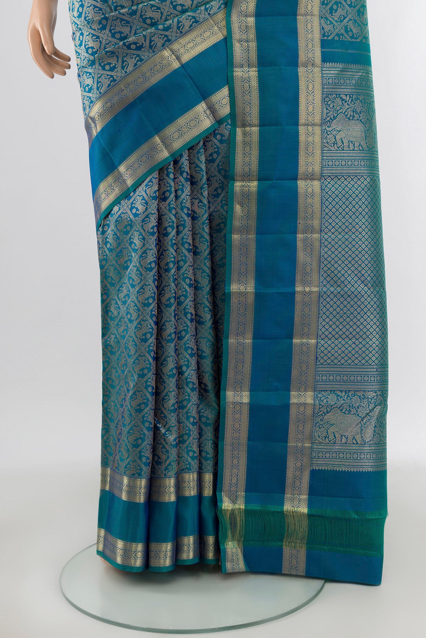 Pleats and pallu of Peacock Blue Kanchipuram Silk Saree with Zari Butta on the body and Zari Border. 