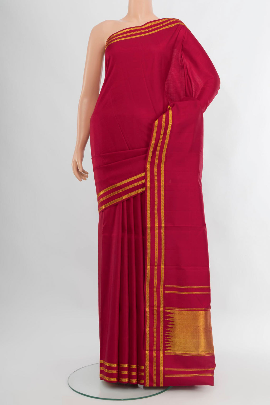 Maroon Kanchipuram Silk Saree with Plain Body and Zari Border.  displayed on a mannequin