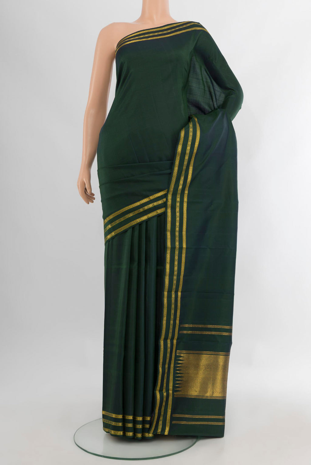 Bottle Green Kanchipuram Silk Saree with Plain Body and Zari Border.  displayed on a mannequin