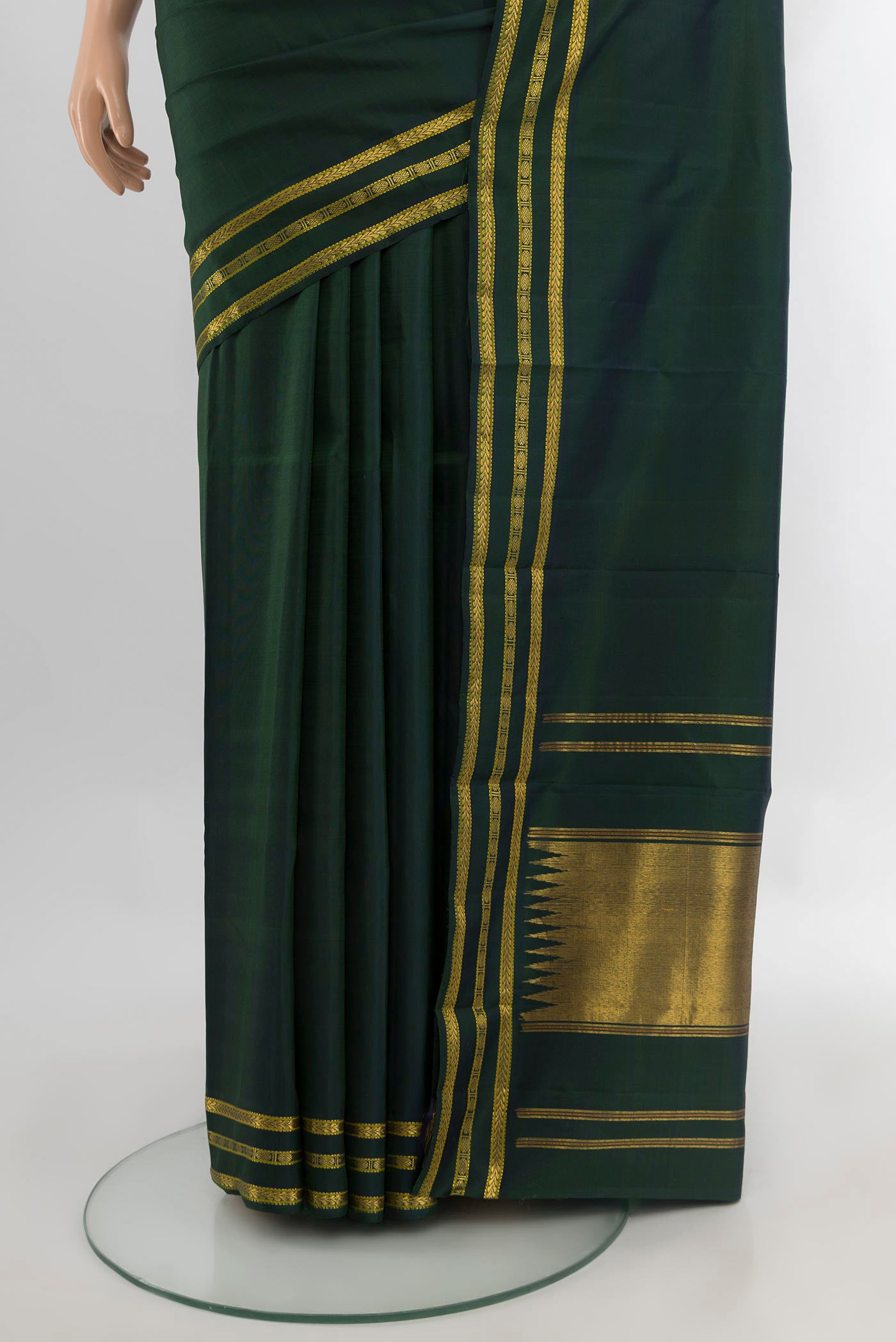 Pleats and pallu of Bottle Green Kanchipuram Silk Saree with Plain Body and Zari Border. 