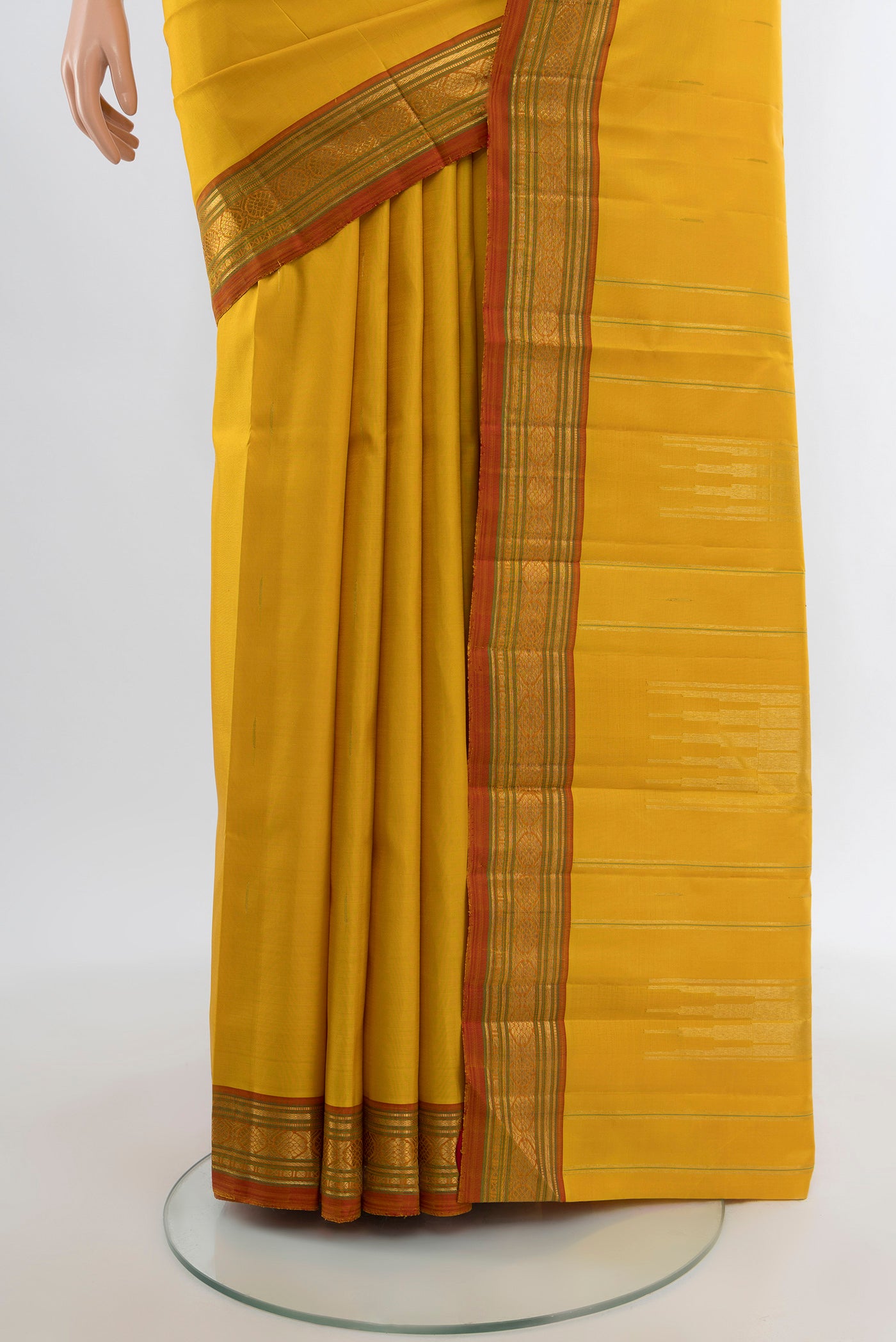 Pleats and pallu of Yellow Kanjivaram Silk Saree with Plain Body and Zari Border. 