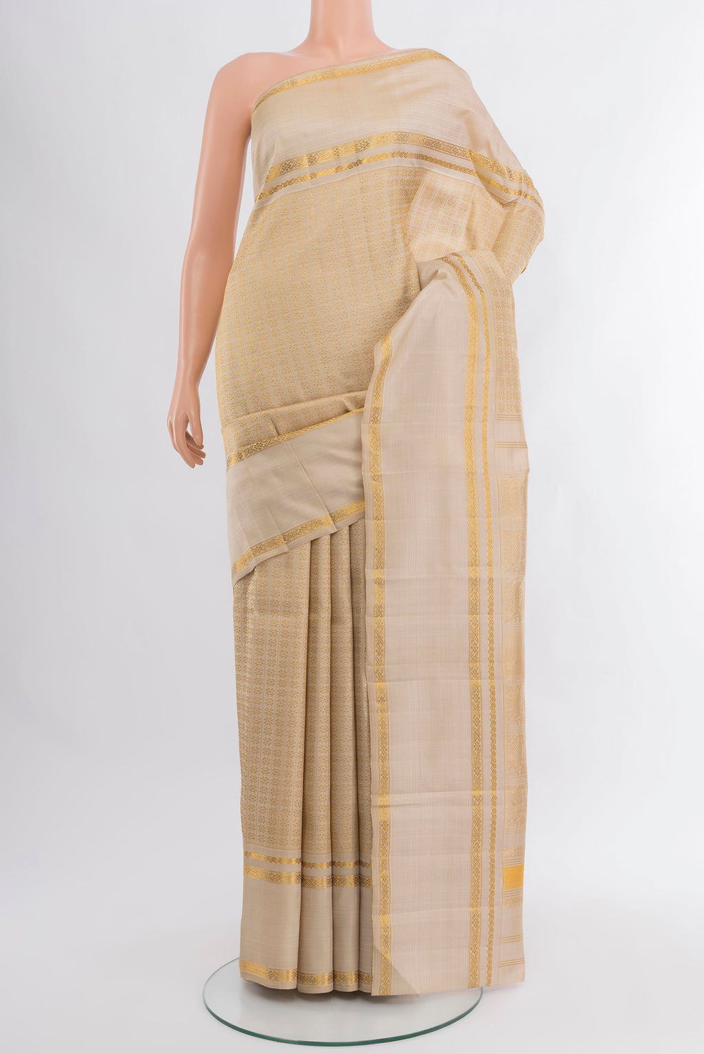 Cream Kanchipuram Silk Saree with Zari Butta on the body and Zari Border.  displayed on a mannequin
