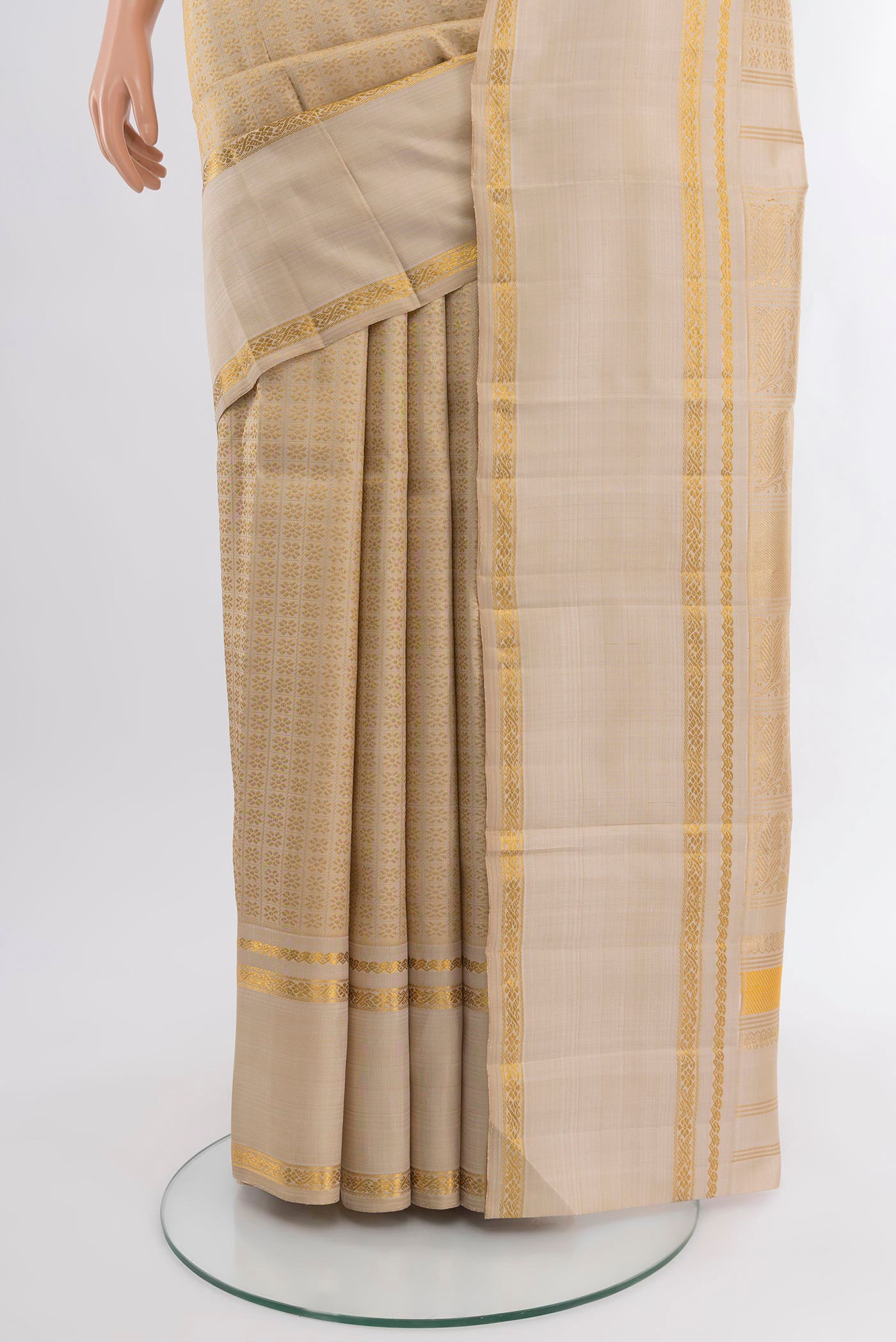 Pleats and pallu of Cream Kanchipuram Silk Saree with Zari Butta on the body and Zari Border. 