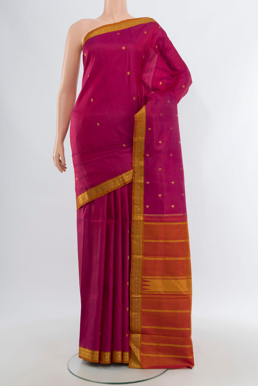 Dark Pink Kanchipuram Silk Saree with Zari Butta on the body and Zari Border.  displayed on a mannequin