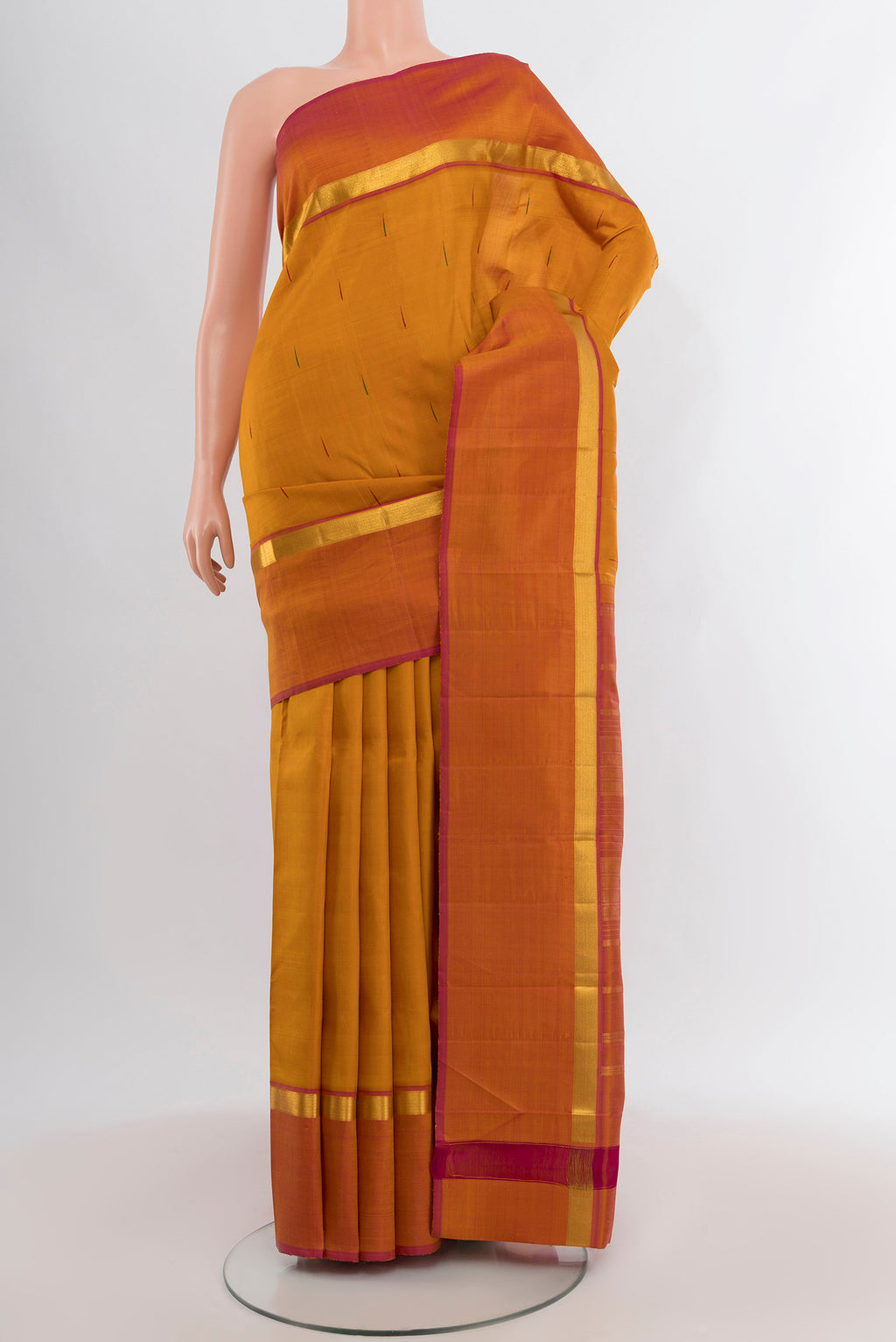 Mustard Kanchipuram Silk Saree with Thread Butta on the body and Zari Border.  displayed on a mannequin