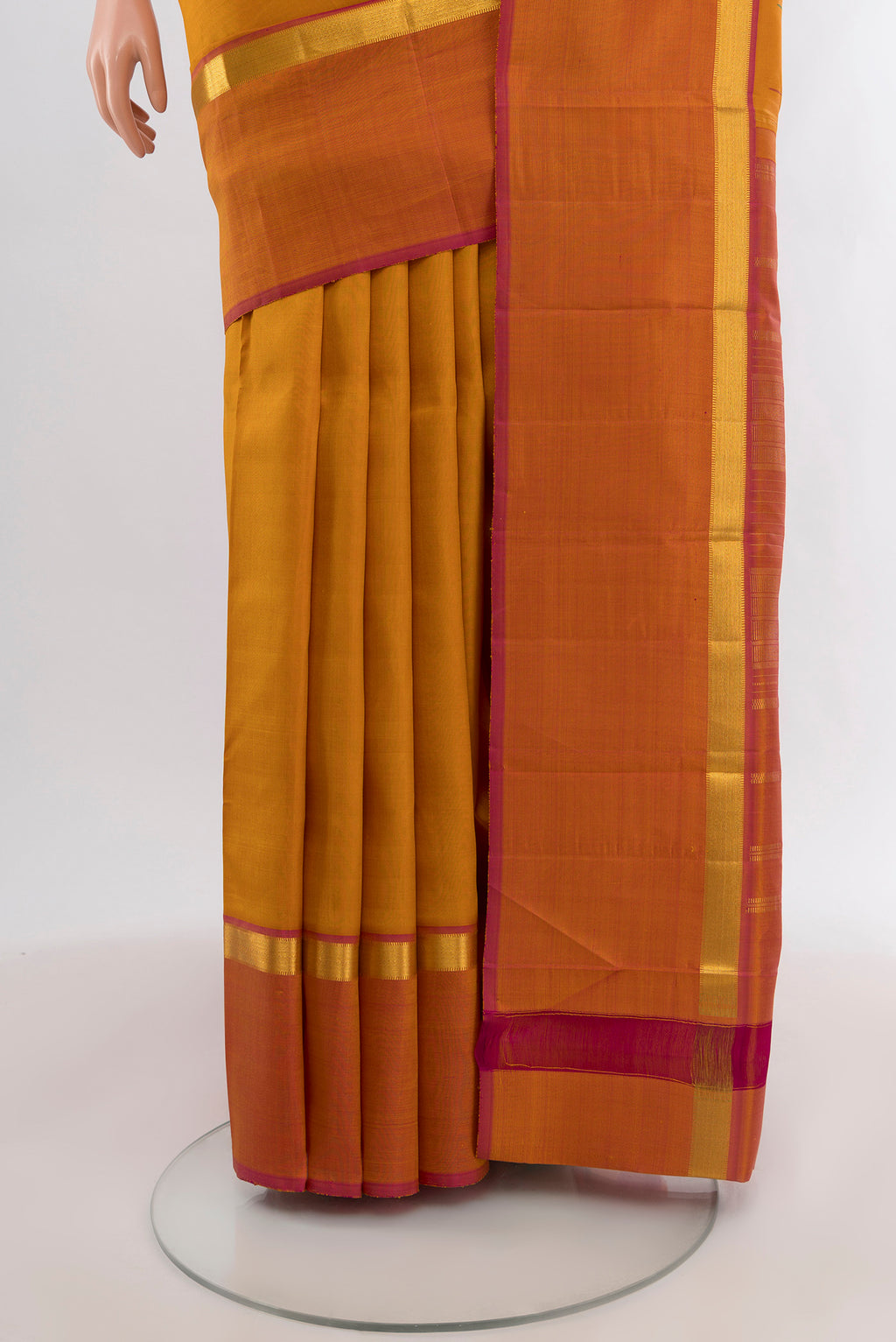 Pleats and pallu of Mustard Kanchipuram Silk Saree with Thread Butta on the body and Zari Border. 