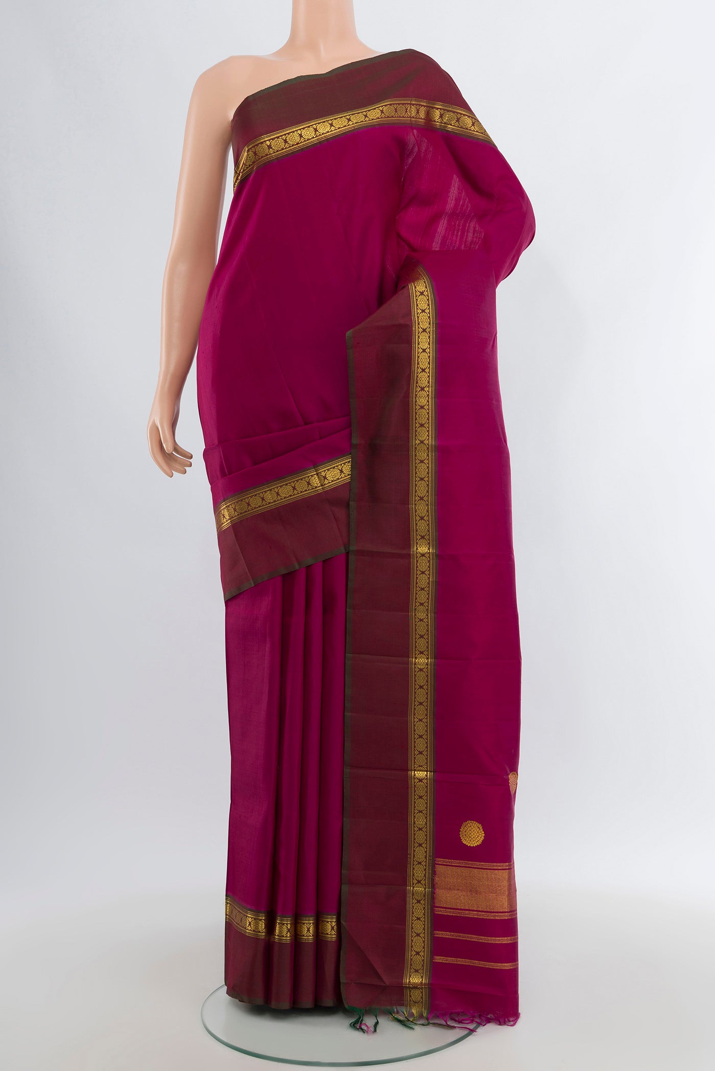 Magenta Kanchipuram Silk Saree with Plain Body and Zari Border.  displayed on a mannequin