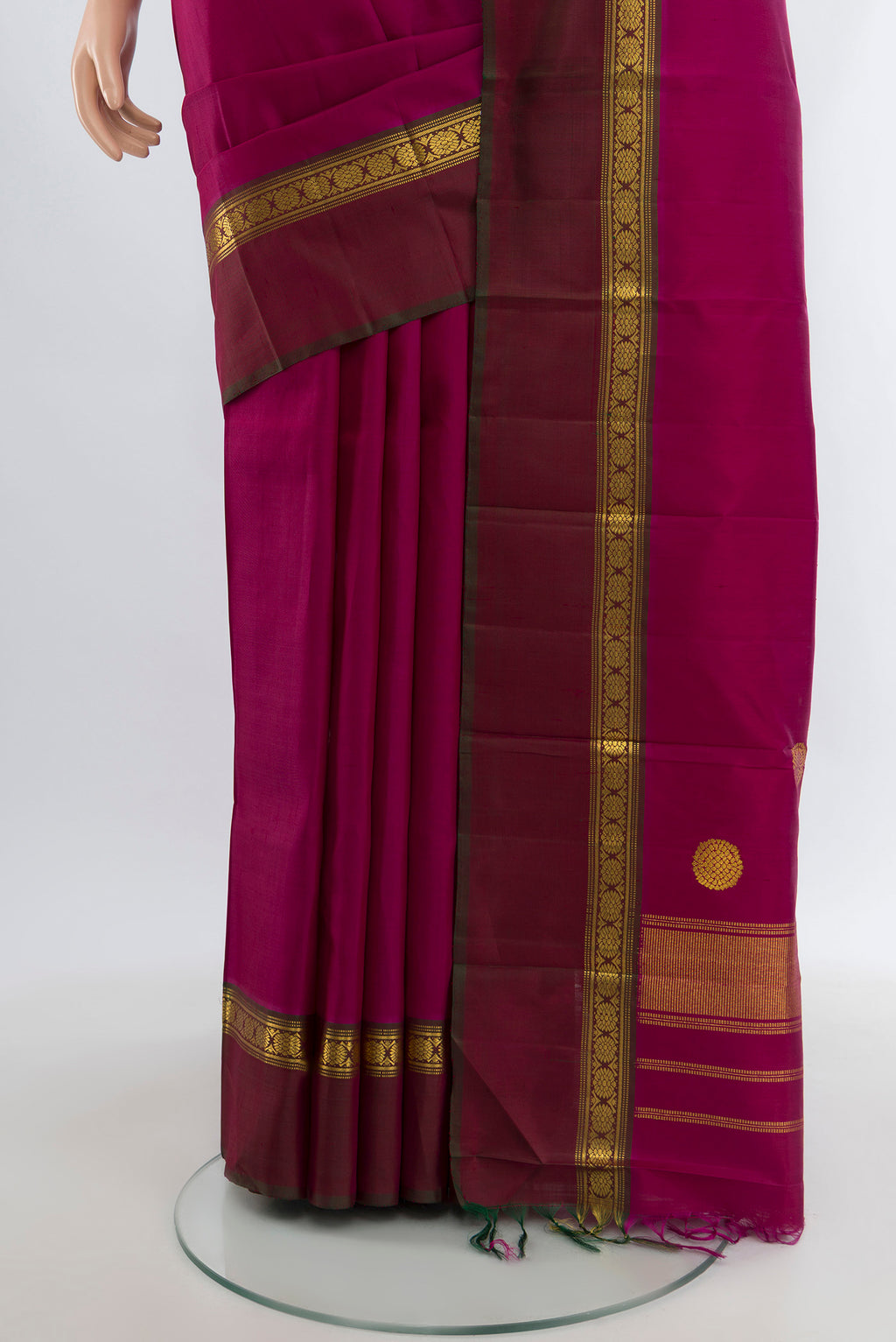 Pleats and pallu of Magenta Kanchipuram Silk Saree with Plain Body and Zari Border. 