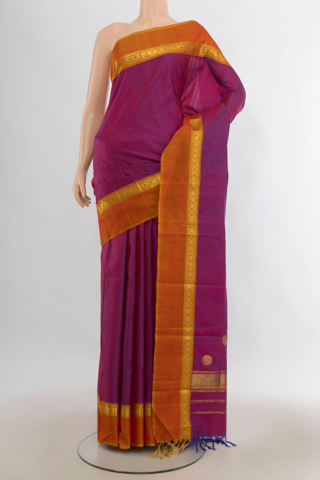 Pure Silk Magenta Kanchipuram Saree with Plain Body and Zari Border.  displayed on a mannequin
