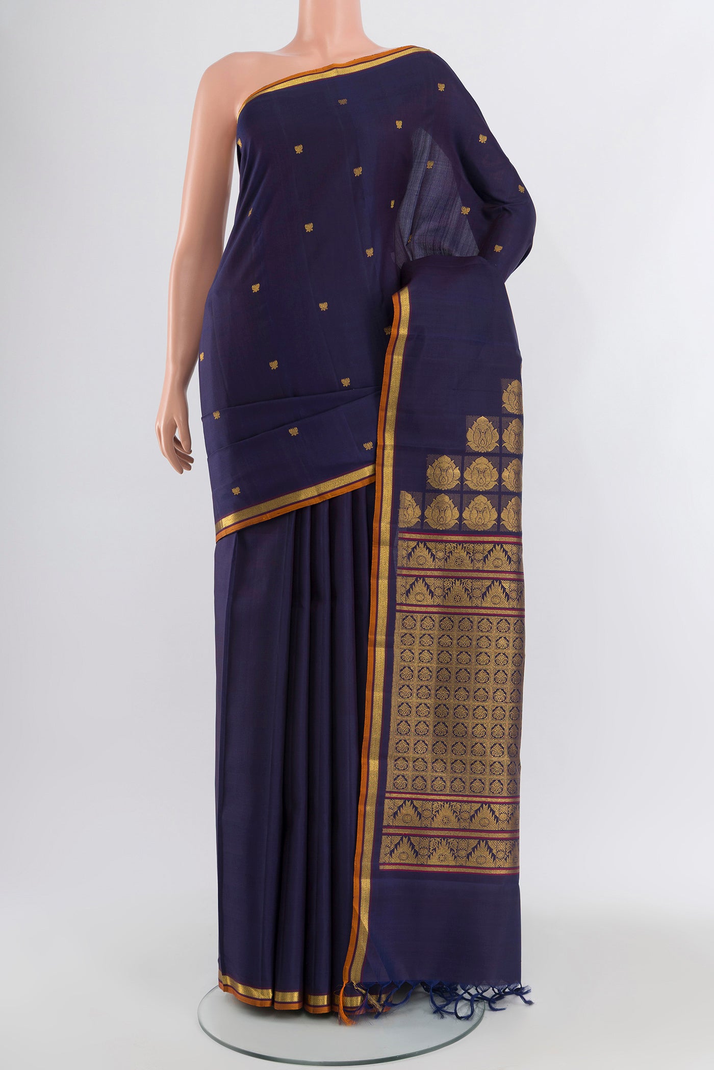 Navy Blue Kanjivaram Silk Saree with Zari Butta on the body and Zari Border.  displayed on a mannequin