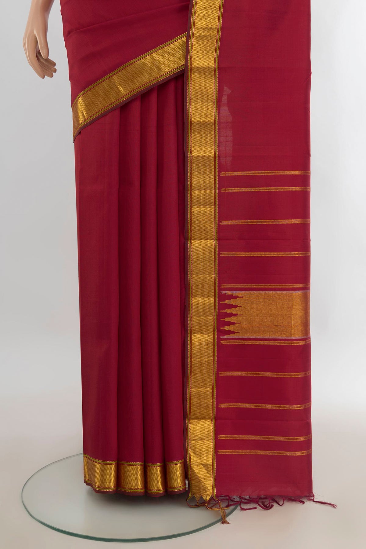 Pleats and pallu of Pure Silk Pure Zari Maroon Kanchipuram Saree with Plain Body and Silk Border. 