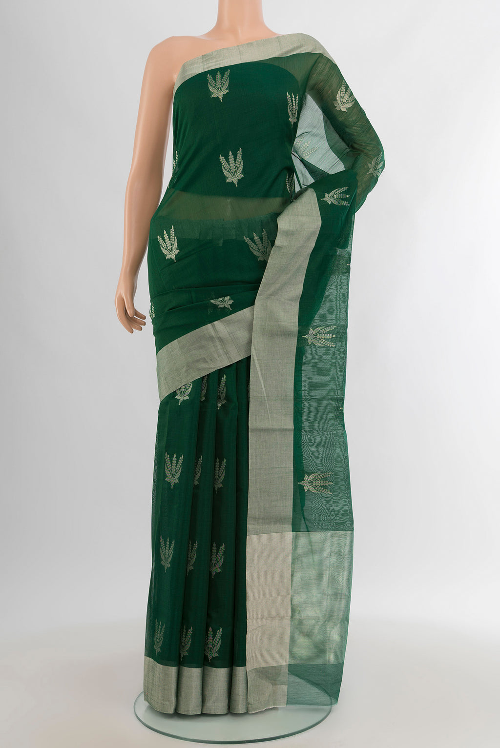 Bottle Green Chanderi Silk Cotton Saree with Zari Butta on the body and Zari Border.  displayed on a mannequin