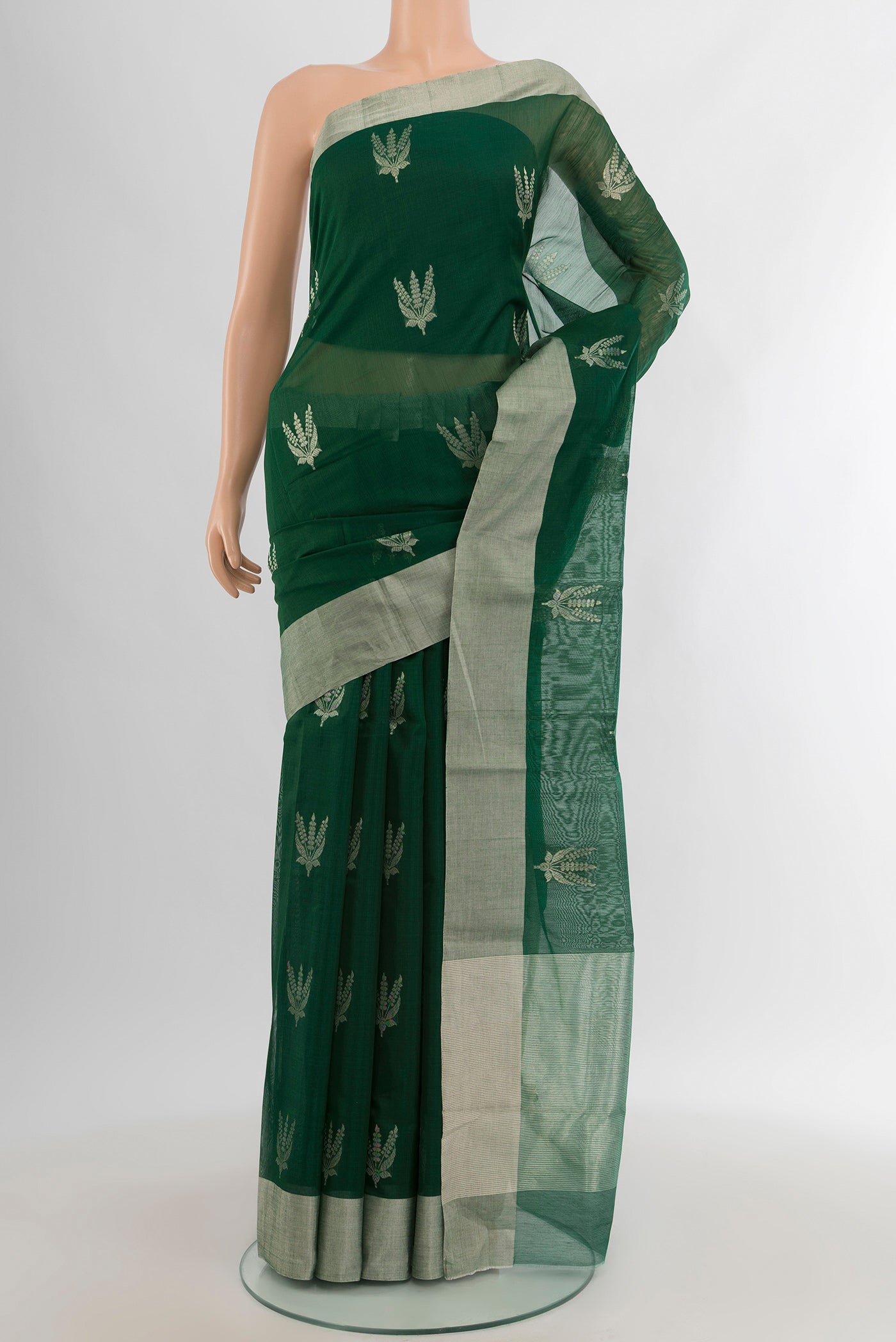 Bottle Green Chanderi Silk Cotton Saree with Zari Butta on the body and Zari Border.  displayed on a mannequin