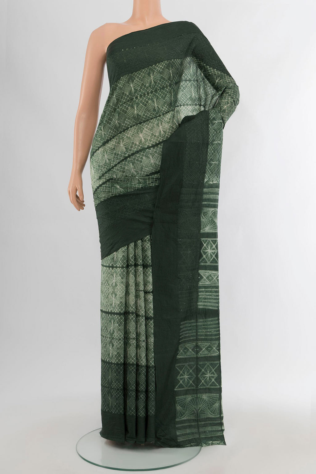 Bottle Green Tussar Silk Saree with Floral Print on the body and Plain Border.  displayed on a mannequin