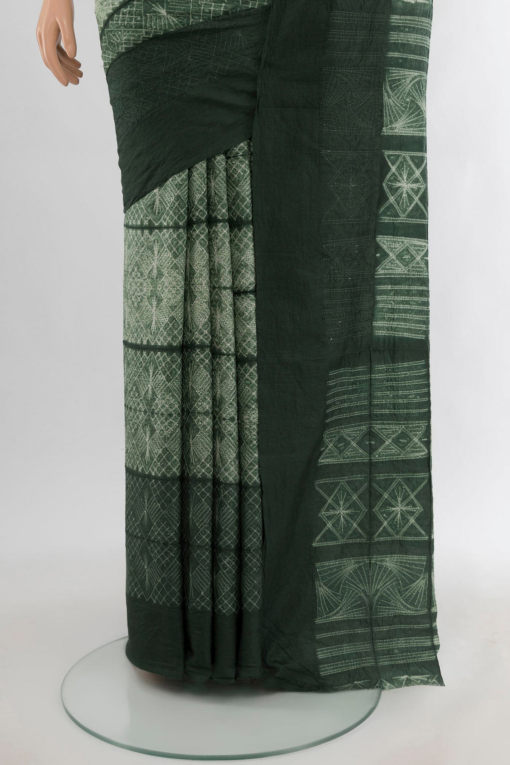 Pleats and pallu of Bottle Green Tussar Silk Saree with Floral Print on the body and Plain Border. 
