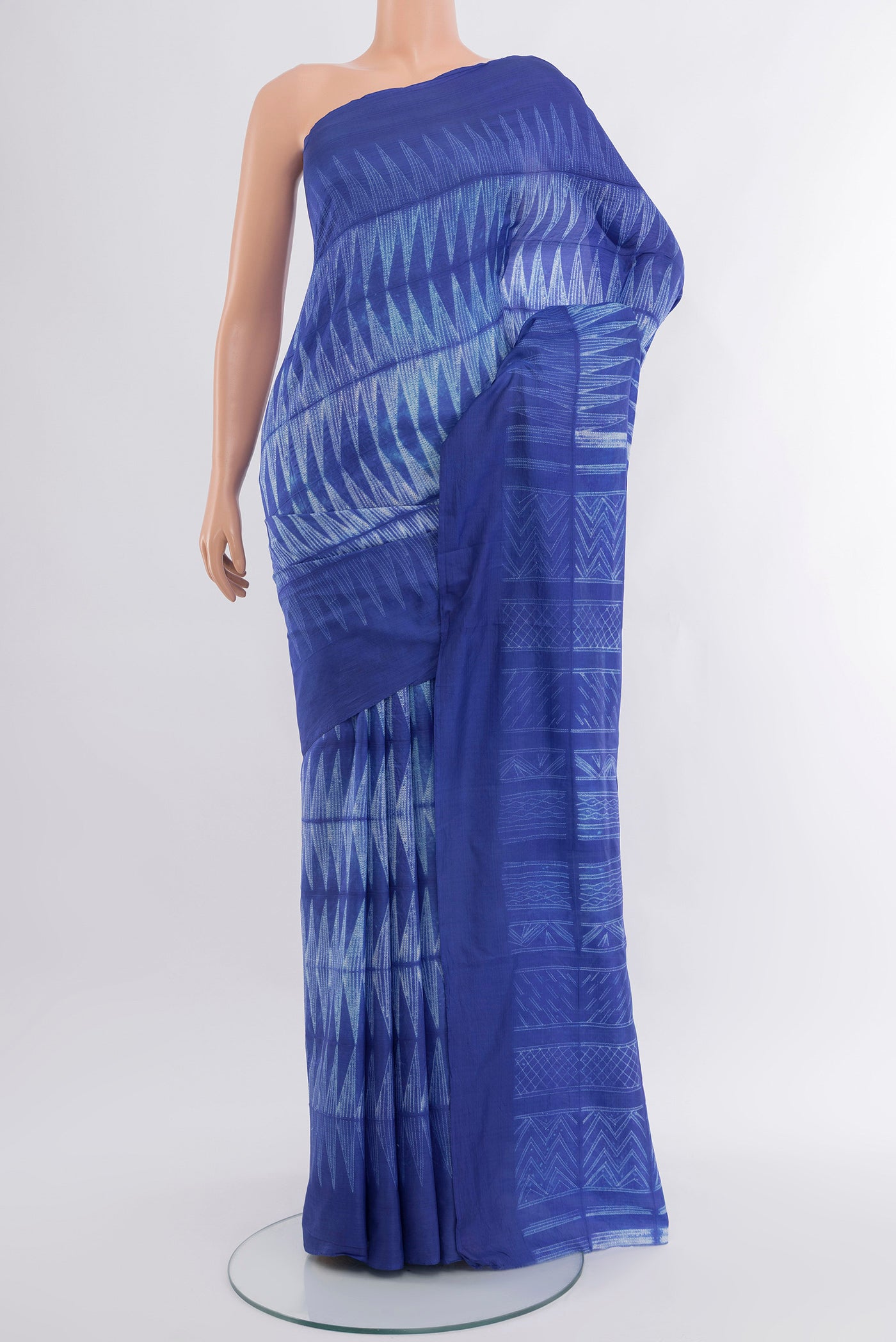 Royal Blue Tussar Silk Saree with Printed design on the body and Printed Border.  displayed on a mannequin