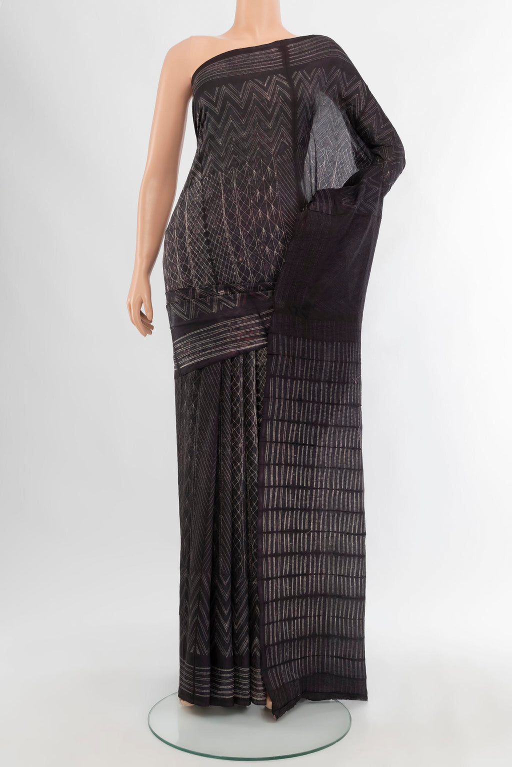 Black Tussar Silk Saree with Printed design on the body and Plain Border.  displayed on a mannequin