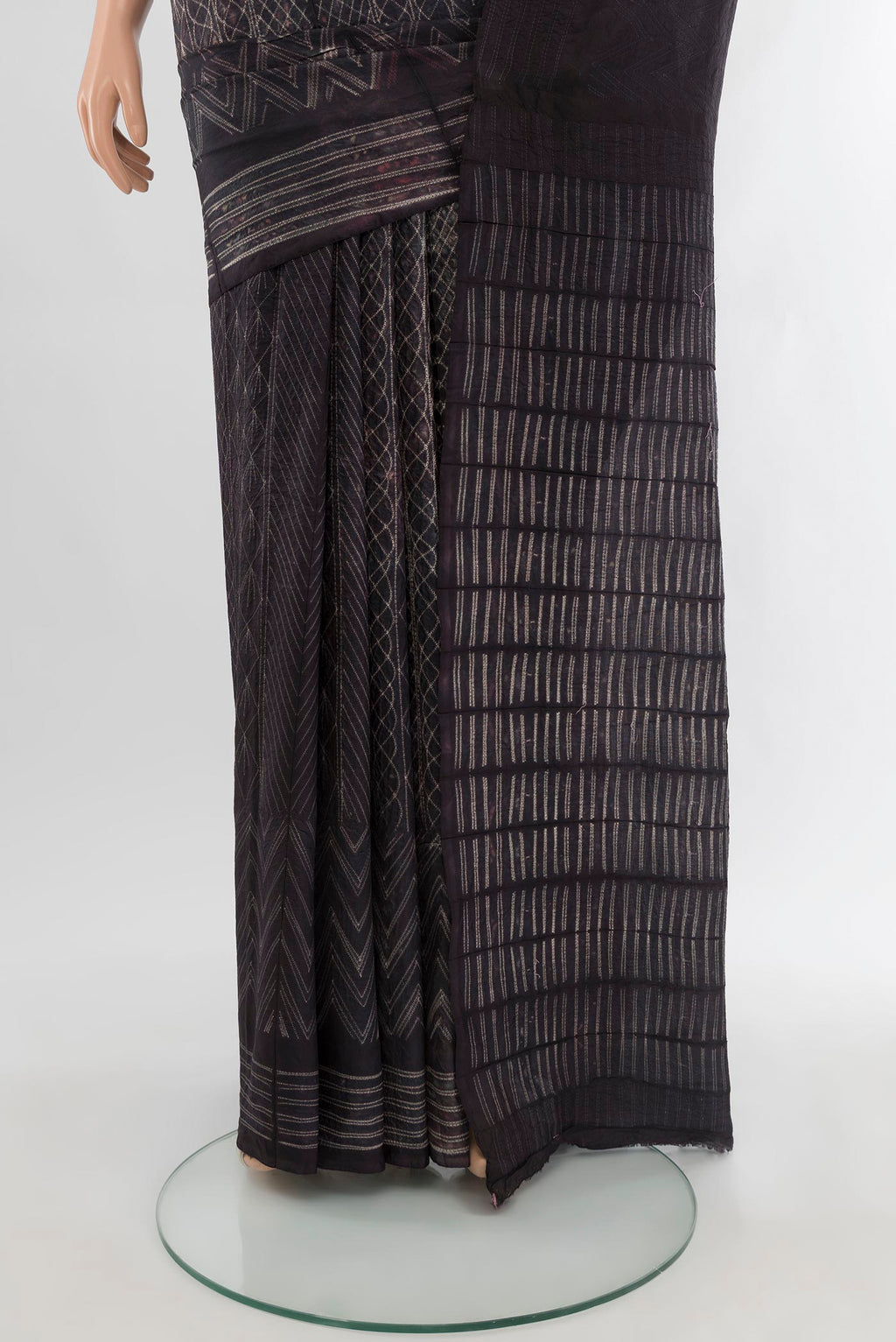 Pleats and pallu of Black Tussar Silk Saree with Printed design on the body and Plain Border. 