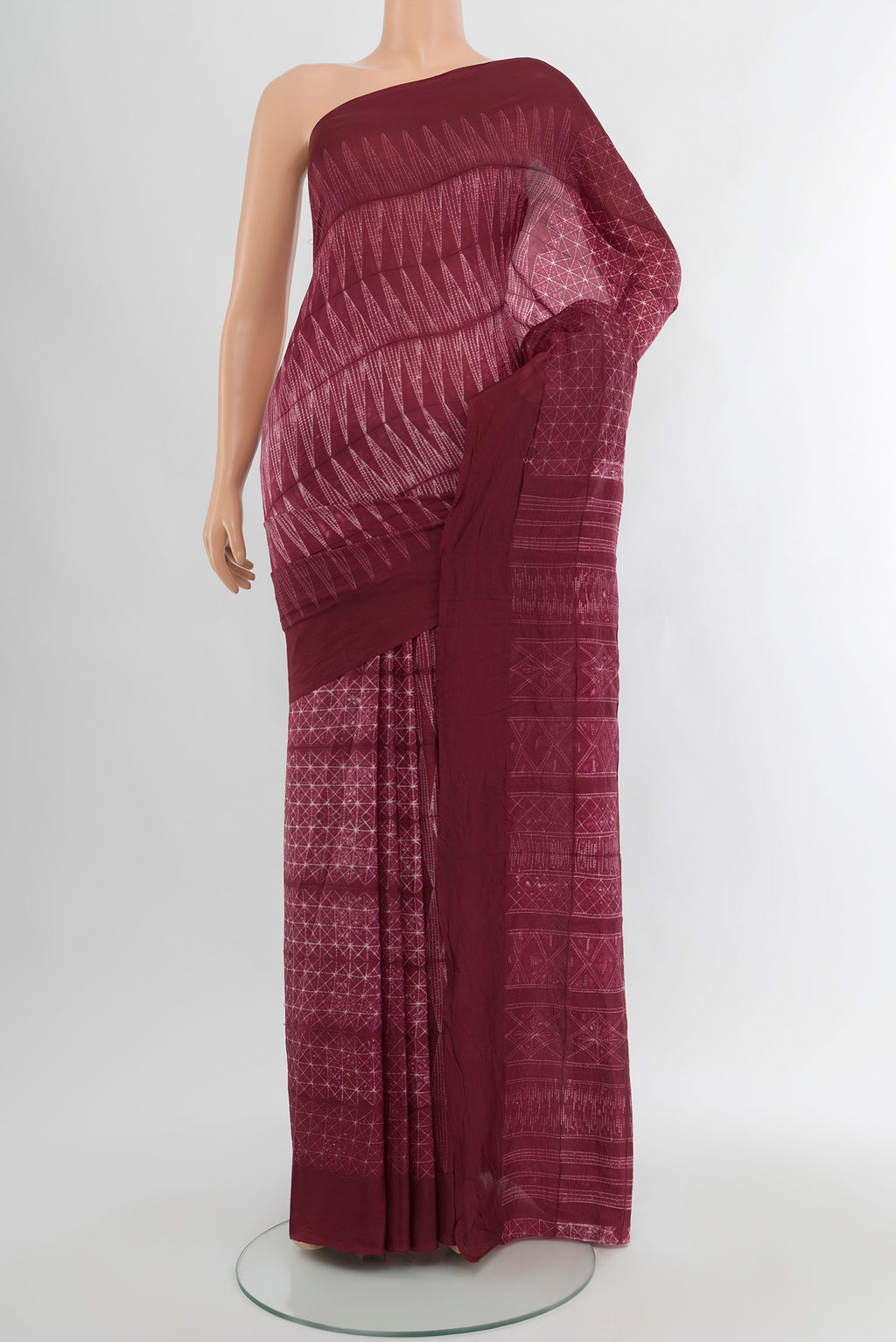 Maroon Tussar Silk Saree with Floral Print on the body and Plain Border.  displayed on a mannequin