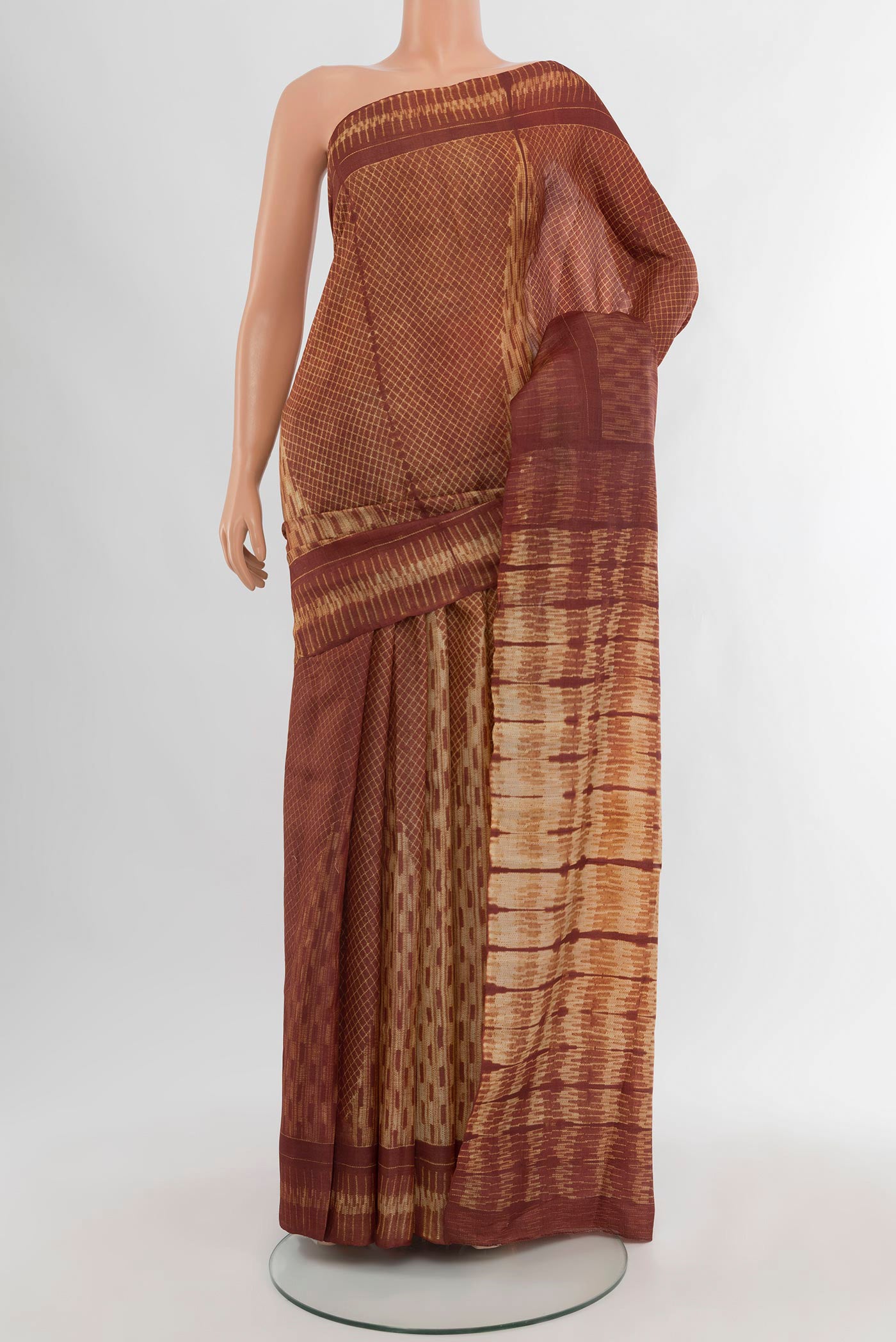 Brown Tussar Silk Saree with Floral Print on the body and Printed Border.  displayed on a mannequin