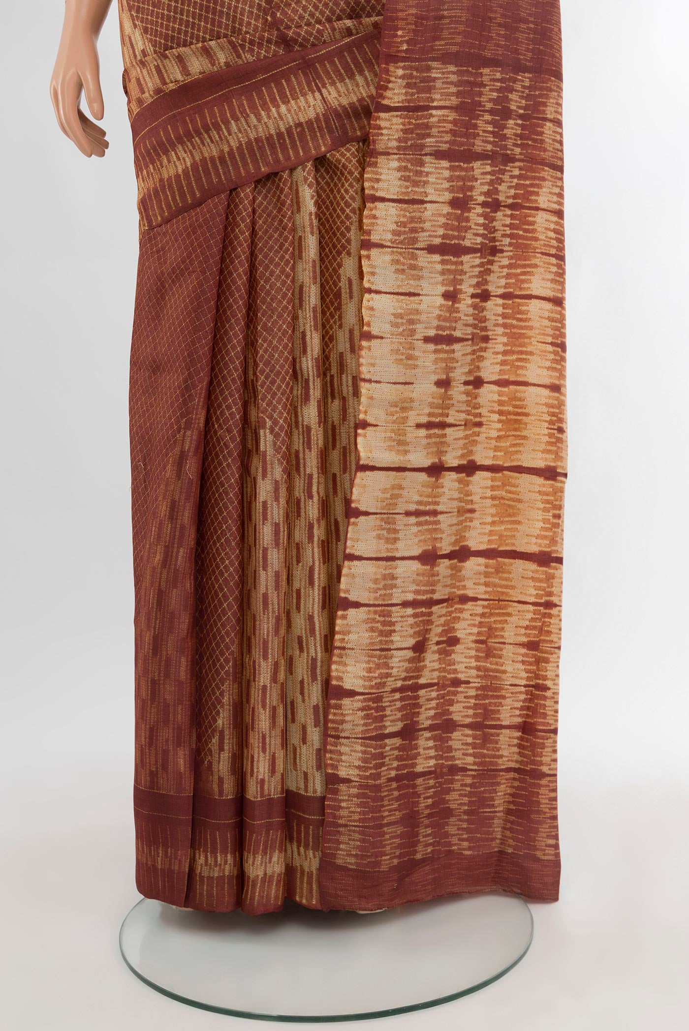 Pleats and pallu of Brown Tussar Silk Saree with Floral Print on the body and Printed Border. 