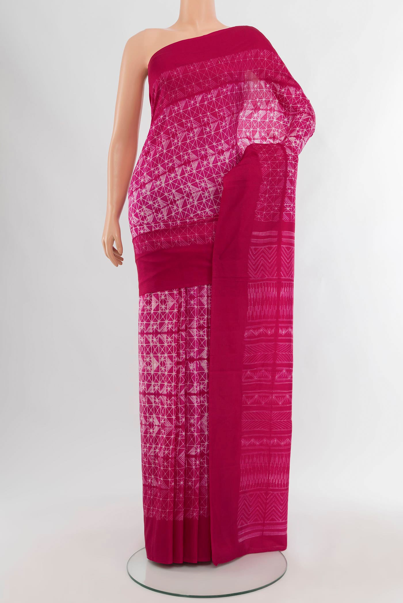 Pink Tussar Silk Saree with Floral Print on the body and Temple Border.  displayed on a mannequin