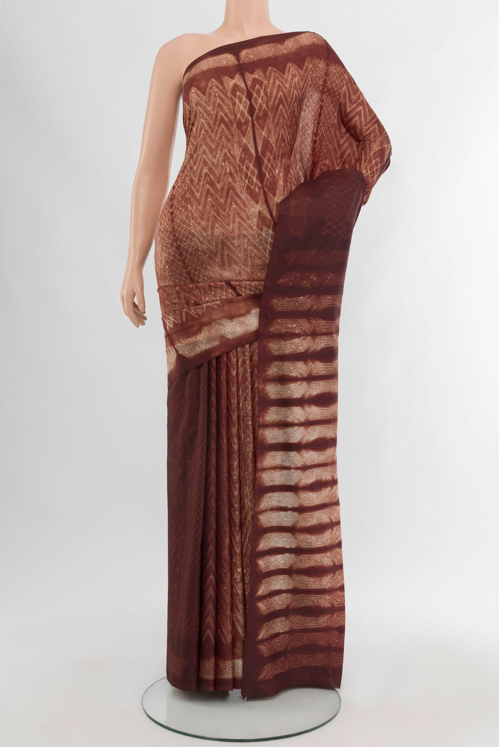 Brown Tussar Silk Saree with Printed design on the body and Printed Border.  displayed on a mannequin