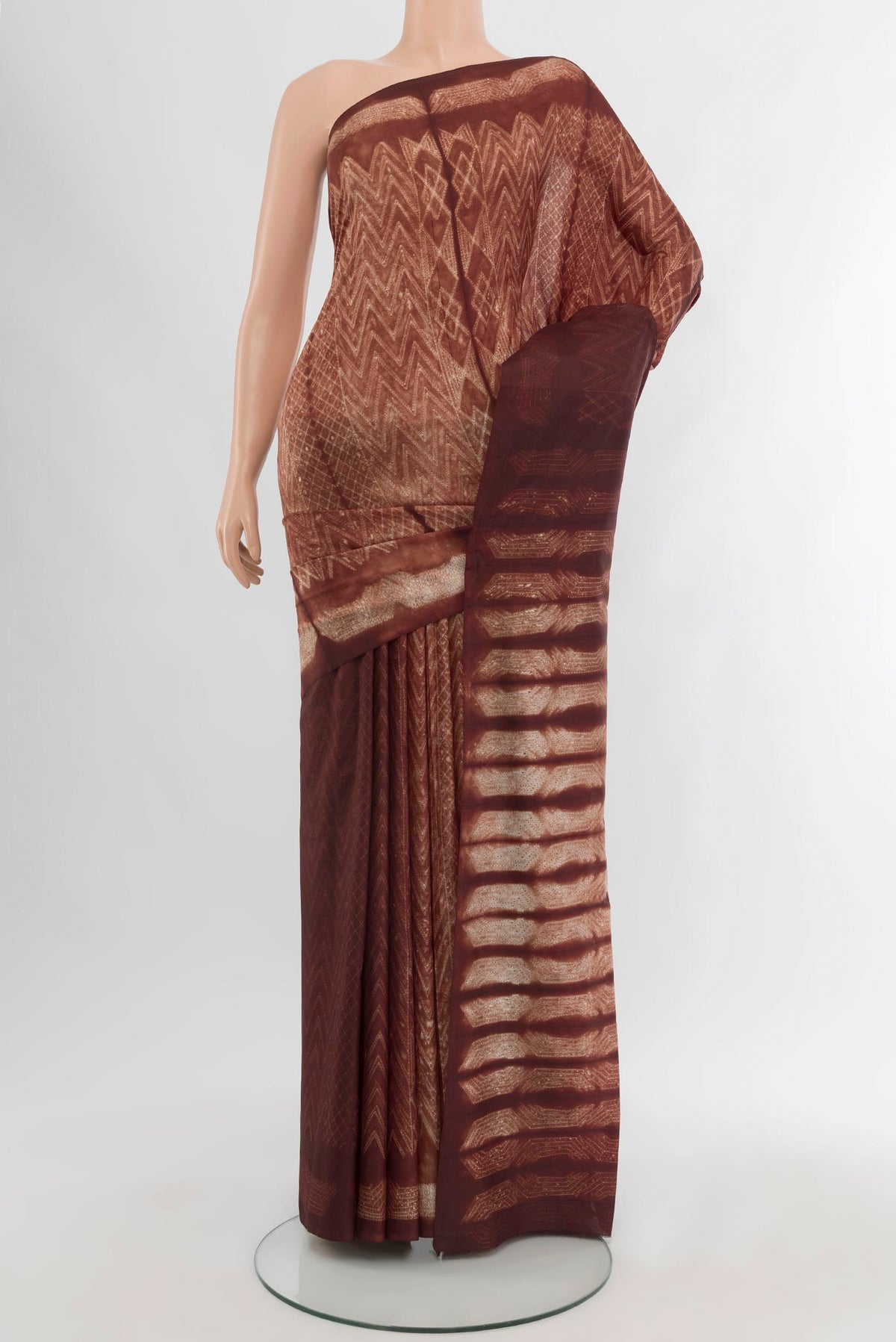 Brown Tussar Silk Saree with Printed design on the body and Printed Border.  displayed on a mannequin