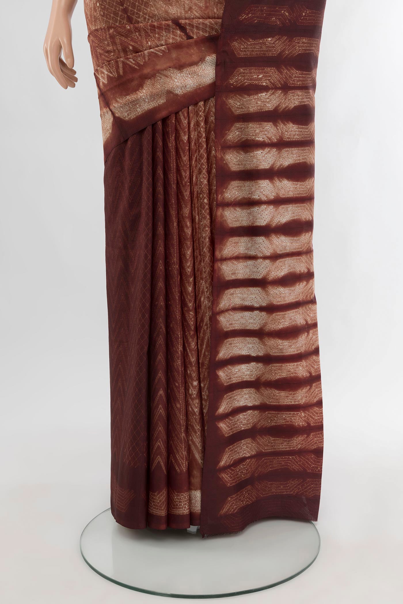 Pleats and pallu of Brown Tussar Silk Saree with Printed design on the body and Printed Border. 