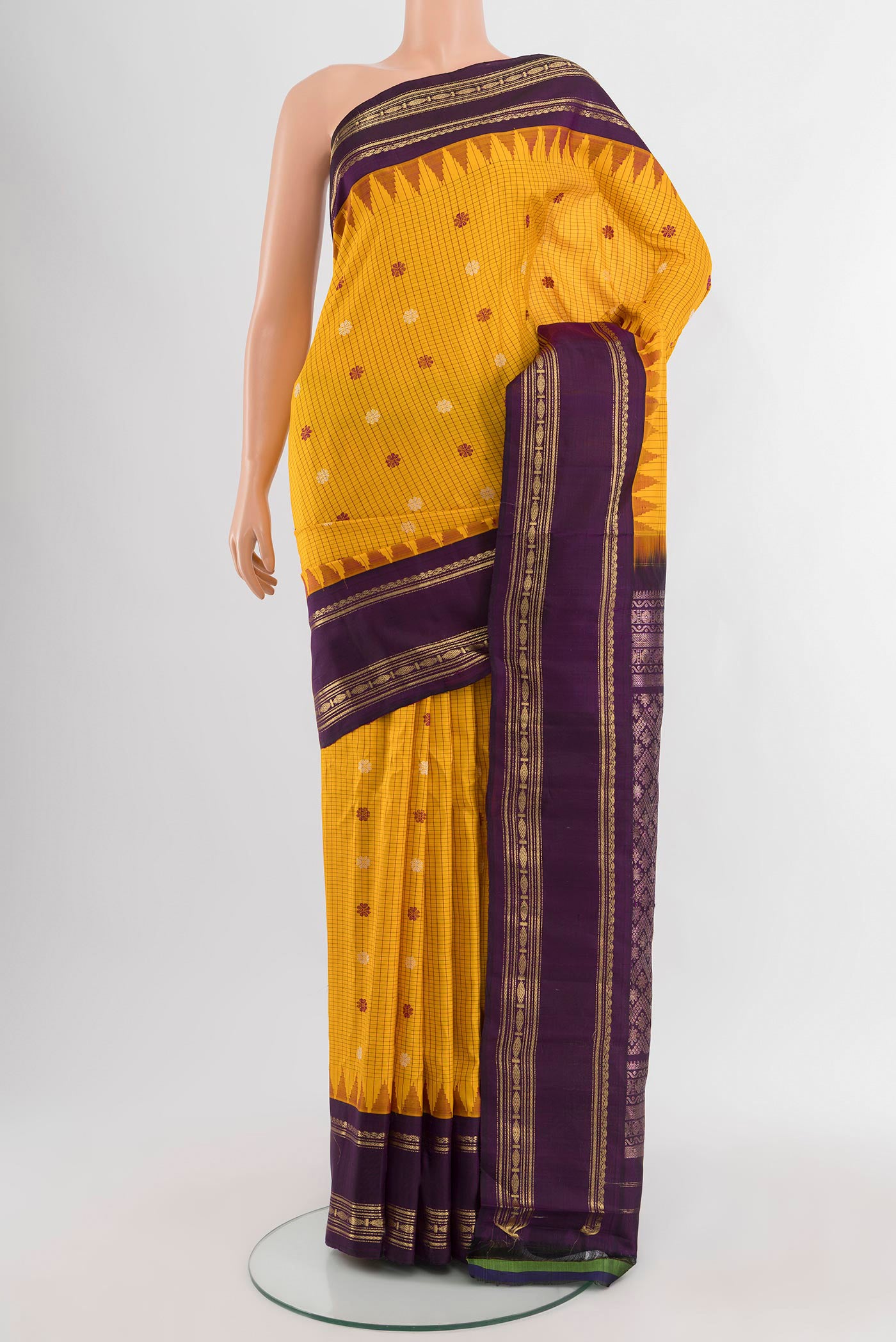 Yellow Gadwal Silk Saree with Checked design on the body and Zari Border.  displayed on a mannequin