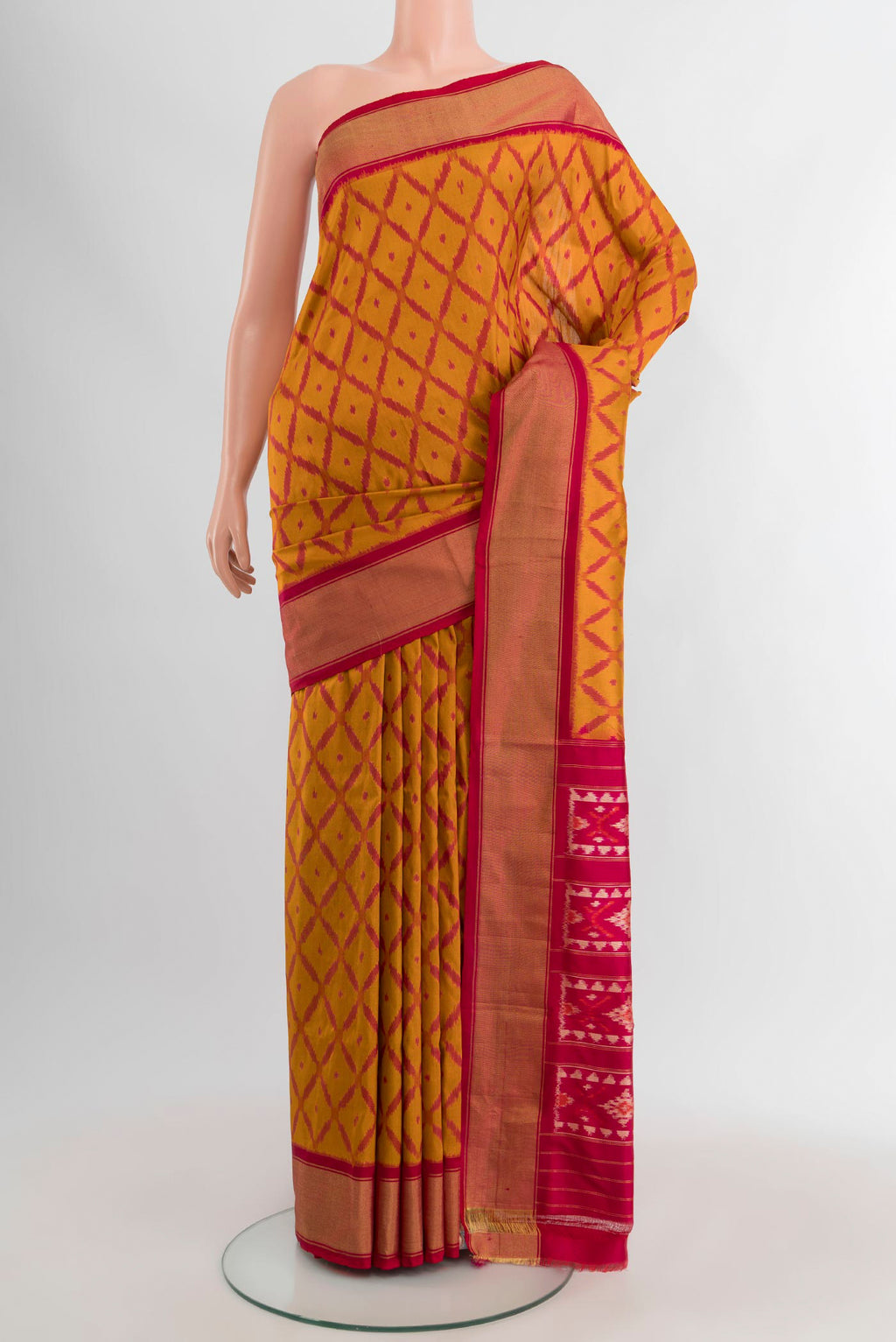 Mustard Pochampally Silk Saree with Ikat design on the body and Zari Border.  displayed on a mannequin
