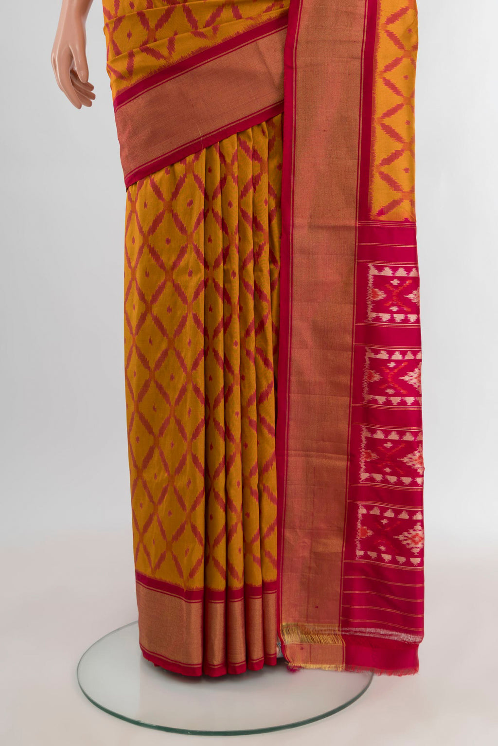 Pleats and pallu of Mustard Pochampally Silk Saree with Ikat design on the body and Zari Border. 
