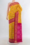Yellow Pochampally Silk Saree with Pure Ikat on the body and Zari Border.  displayed on a mannequin