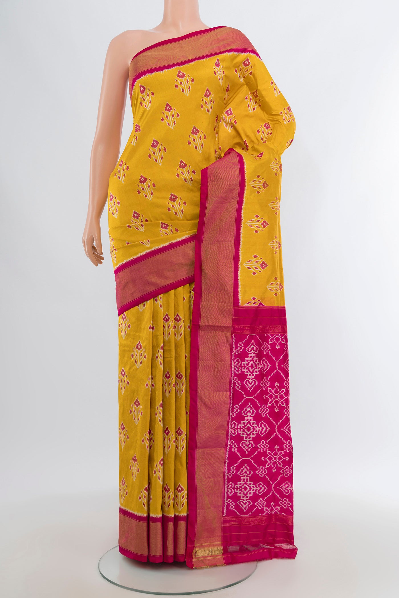 Yellow Pochampally Silk Saree with Pure Ikat on the body and Zari Border.  displayed on a mannequin