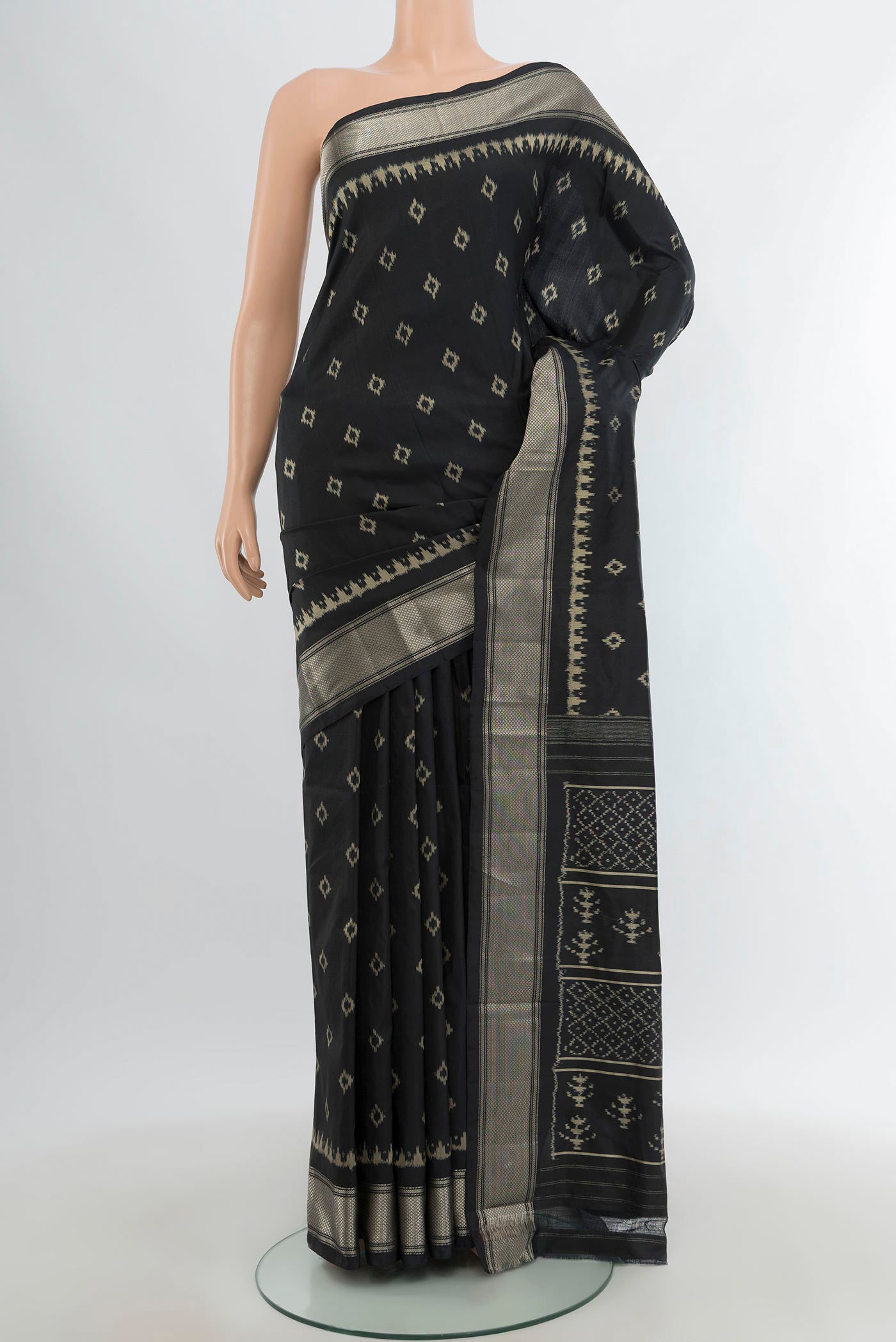 Black Pochampally Silk Saree with Pure Ikat on the body and Zari Border.  displayed on a mannequin