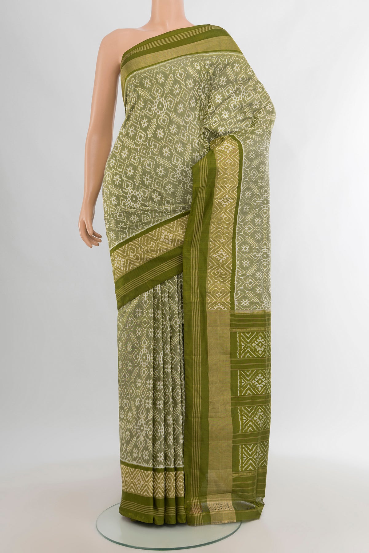 Light Green Pochampally Silk Saree with Pure Ikat on the body and Zari Border.  displayed on a mannequin
