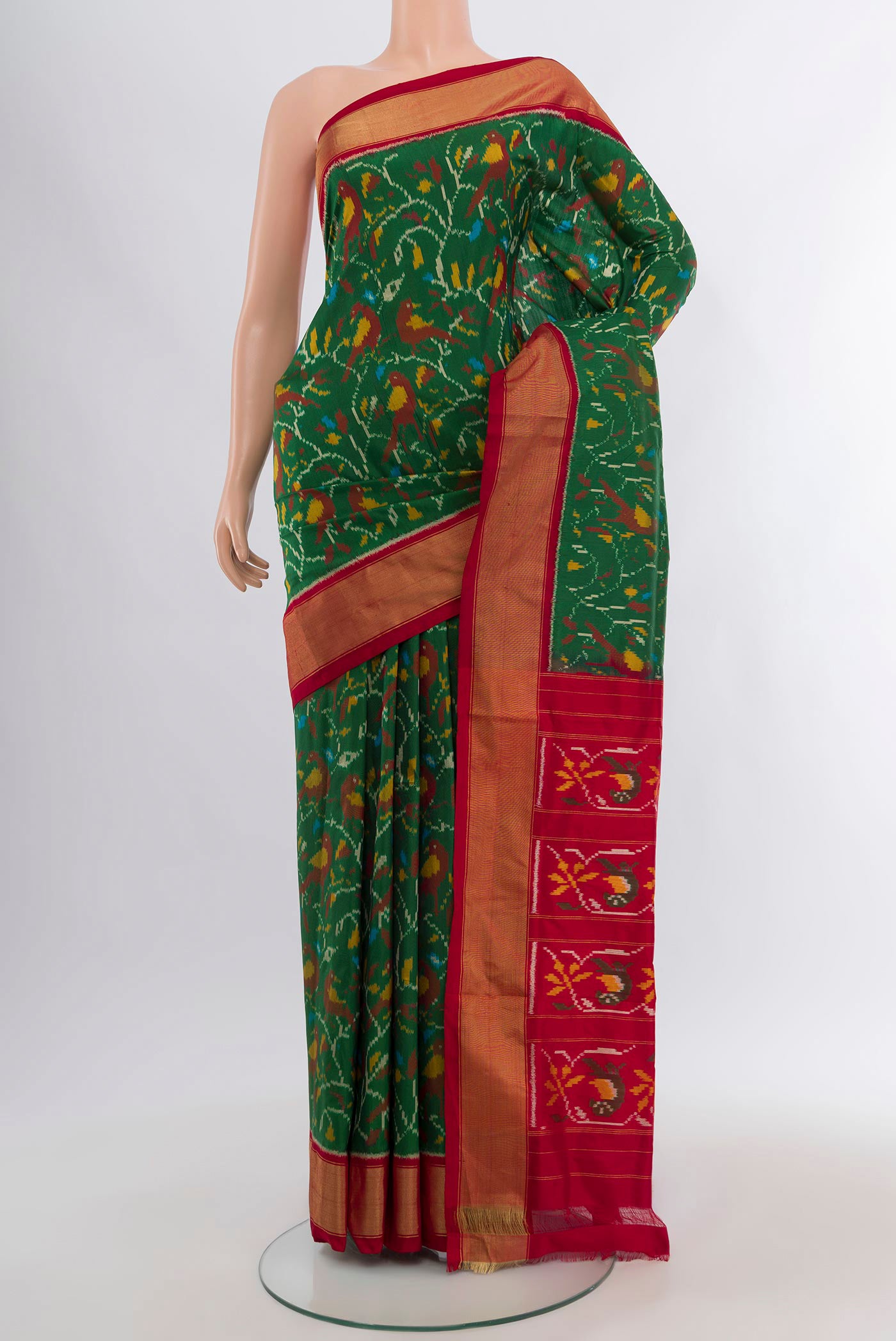Green Pochampally Silk Saree with Ikat design on the body and Zari Border.  displayed on a mannequin
