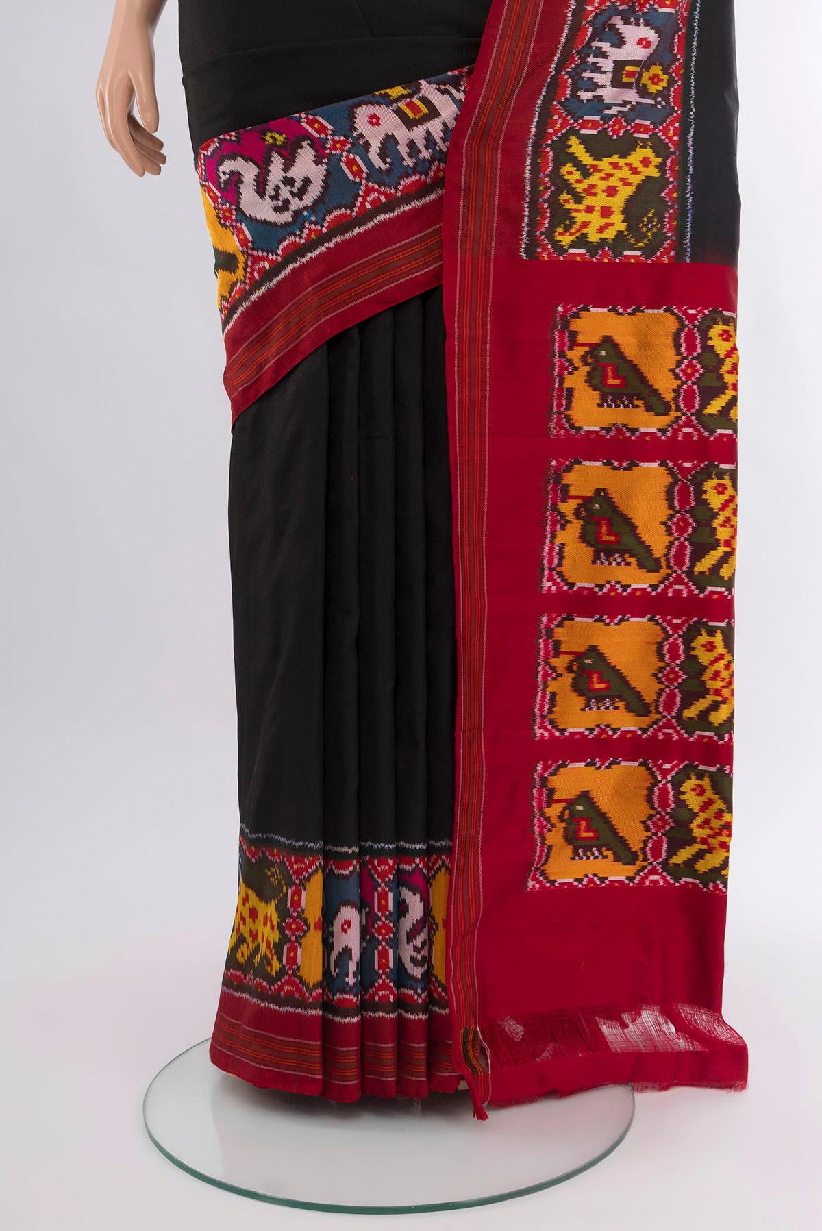 Pleats and pallu of Black Pochampally Silk Saree with Plain Body and Ikat Border. 