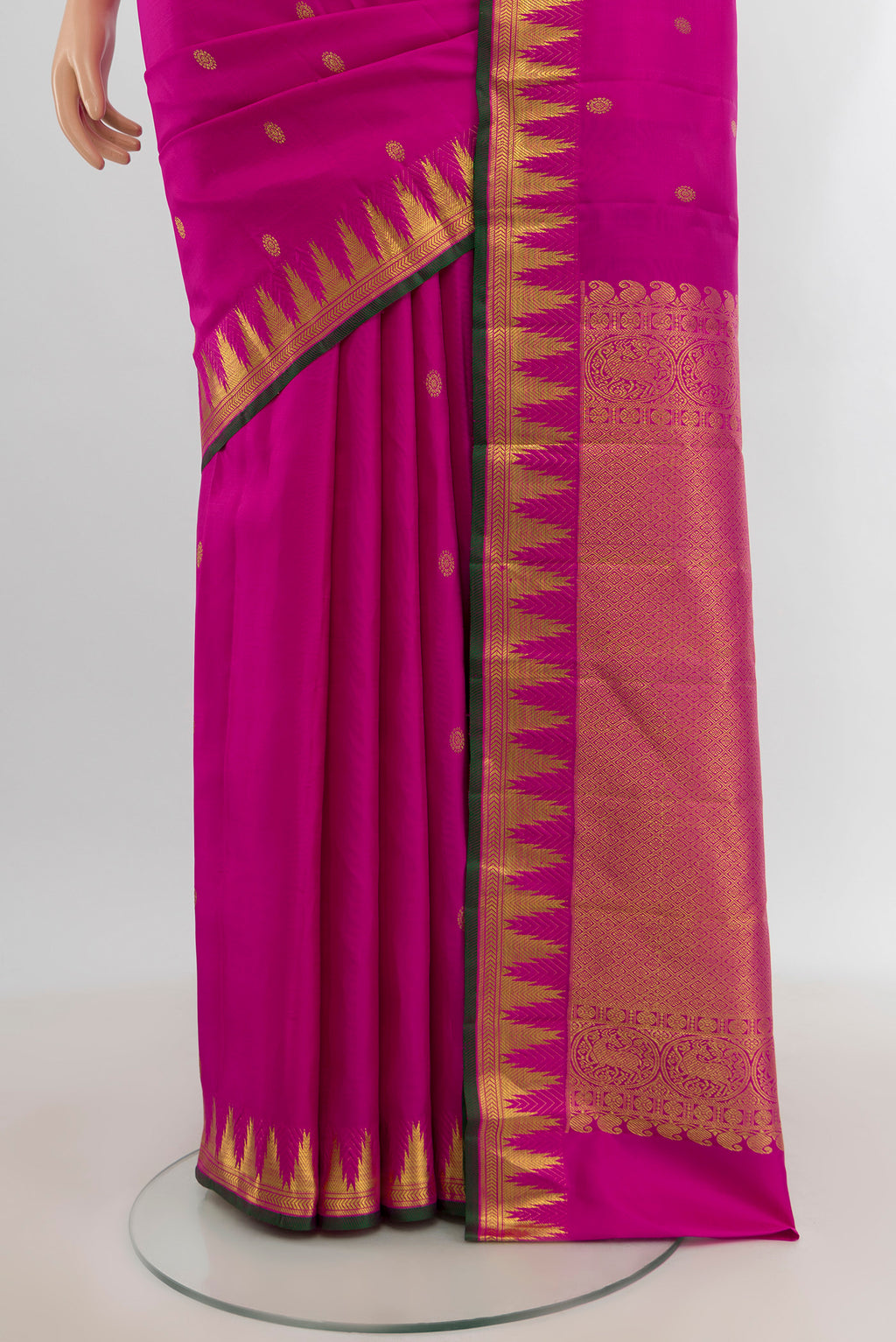 Pleats and pallu of Rani Pink Kanjivaram Silk Saree with Zari Butta on the body and Zari Border. 